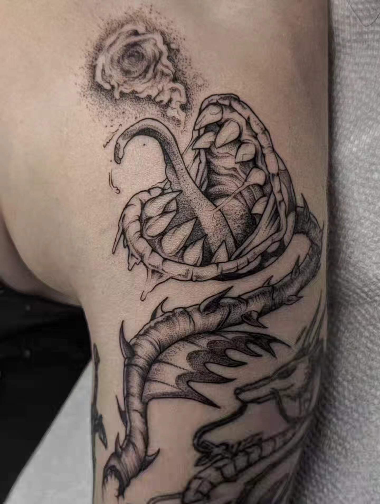 Snake and flower dotwork tattoo on the forearm by Luca