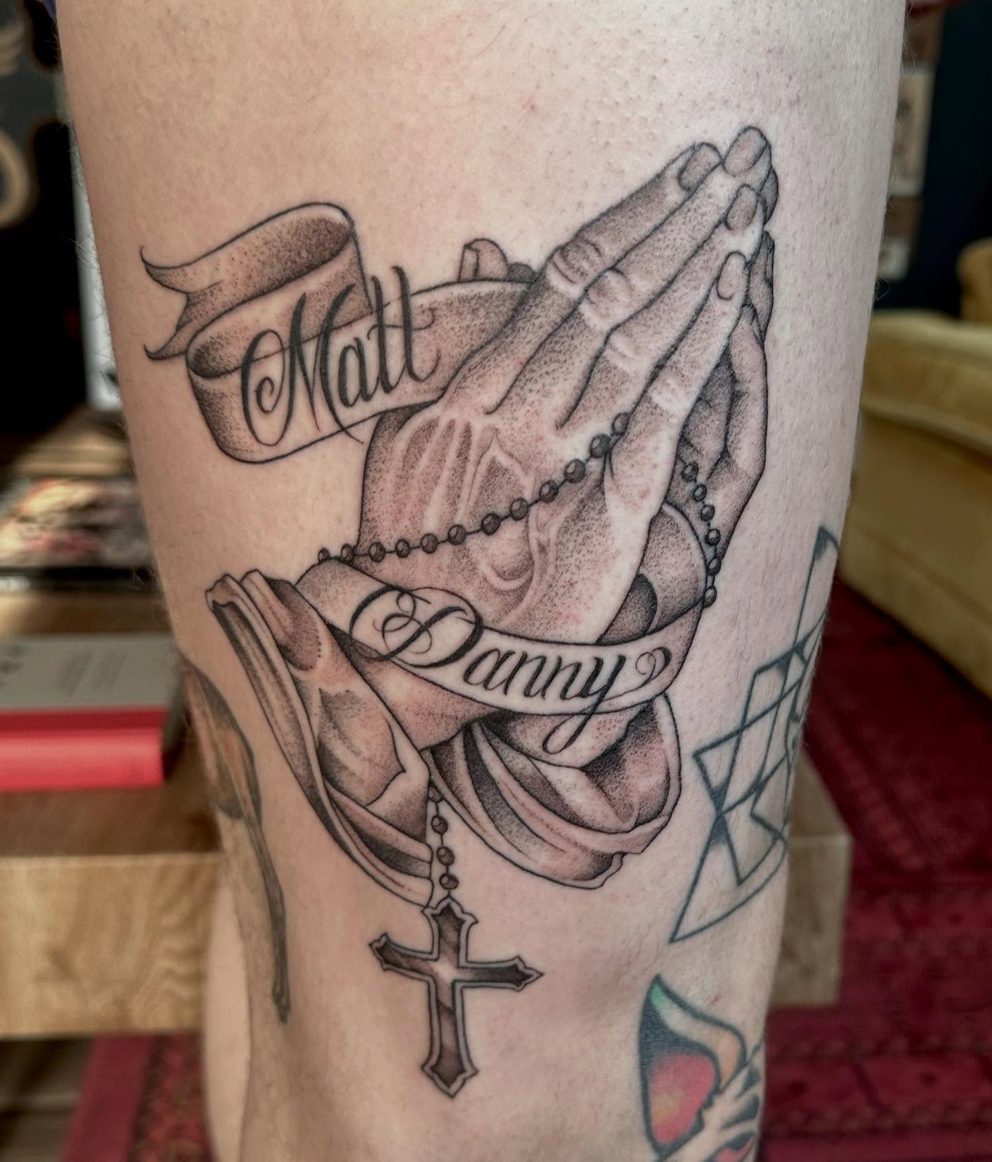Praying hands with rosary realism tattoo on the forearm by Lia Massari