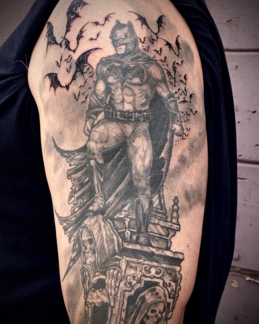 Batman realism tattoo on the upper arm by Culleton Paramore