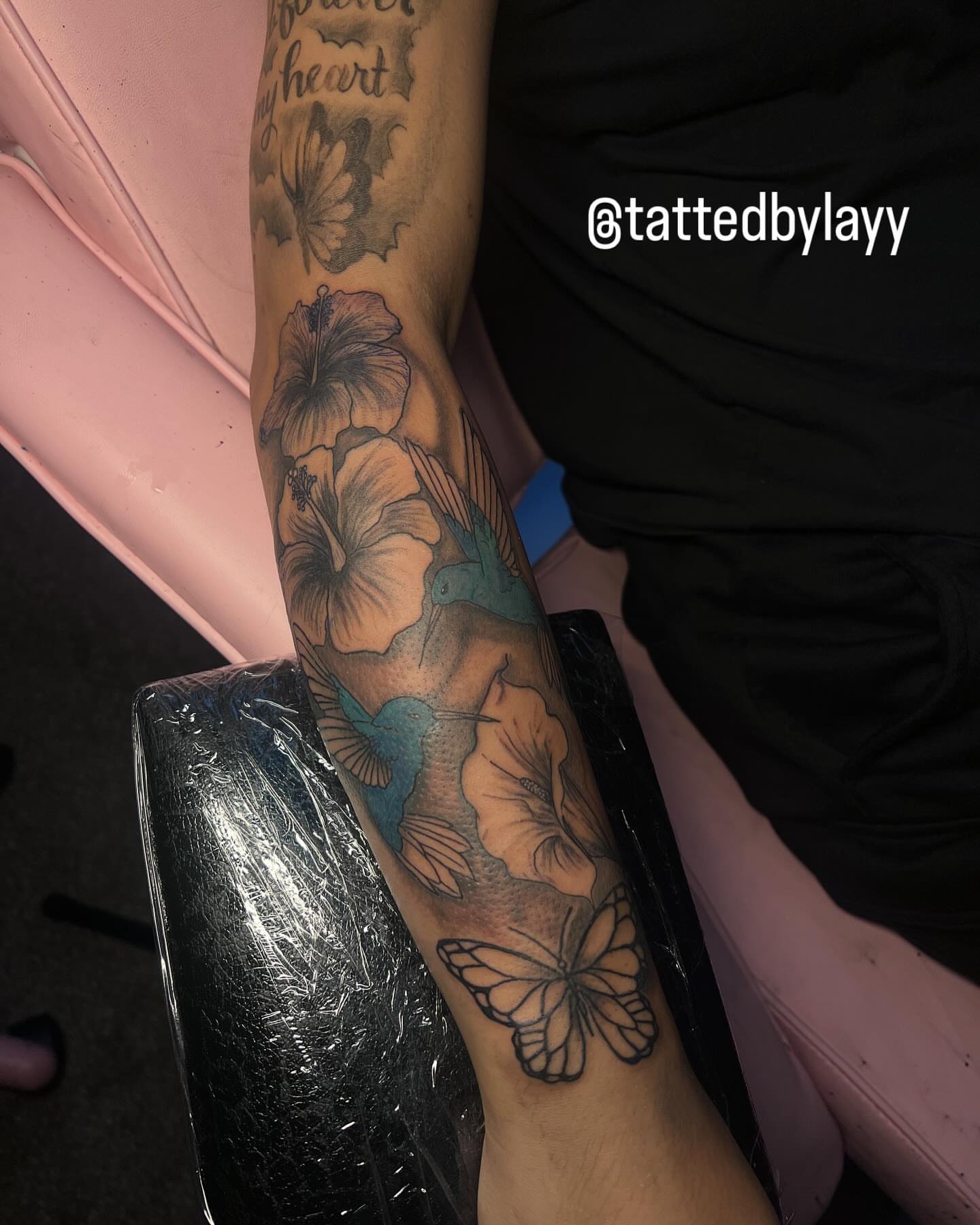 Flowers and hummingbirds realism tattoo on the forearm by Tatted By Layy