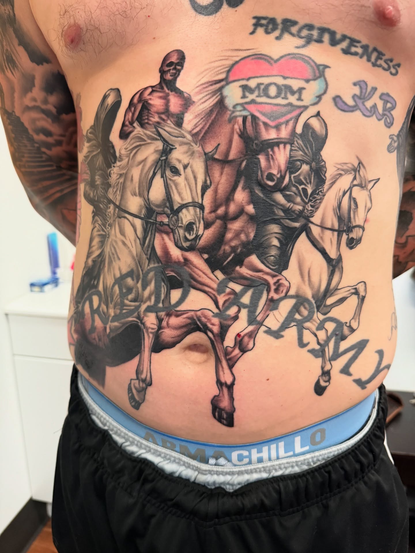 Horses and riders American traditional tattoo on the torso by Jeremy Utley