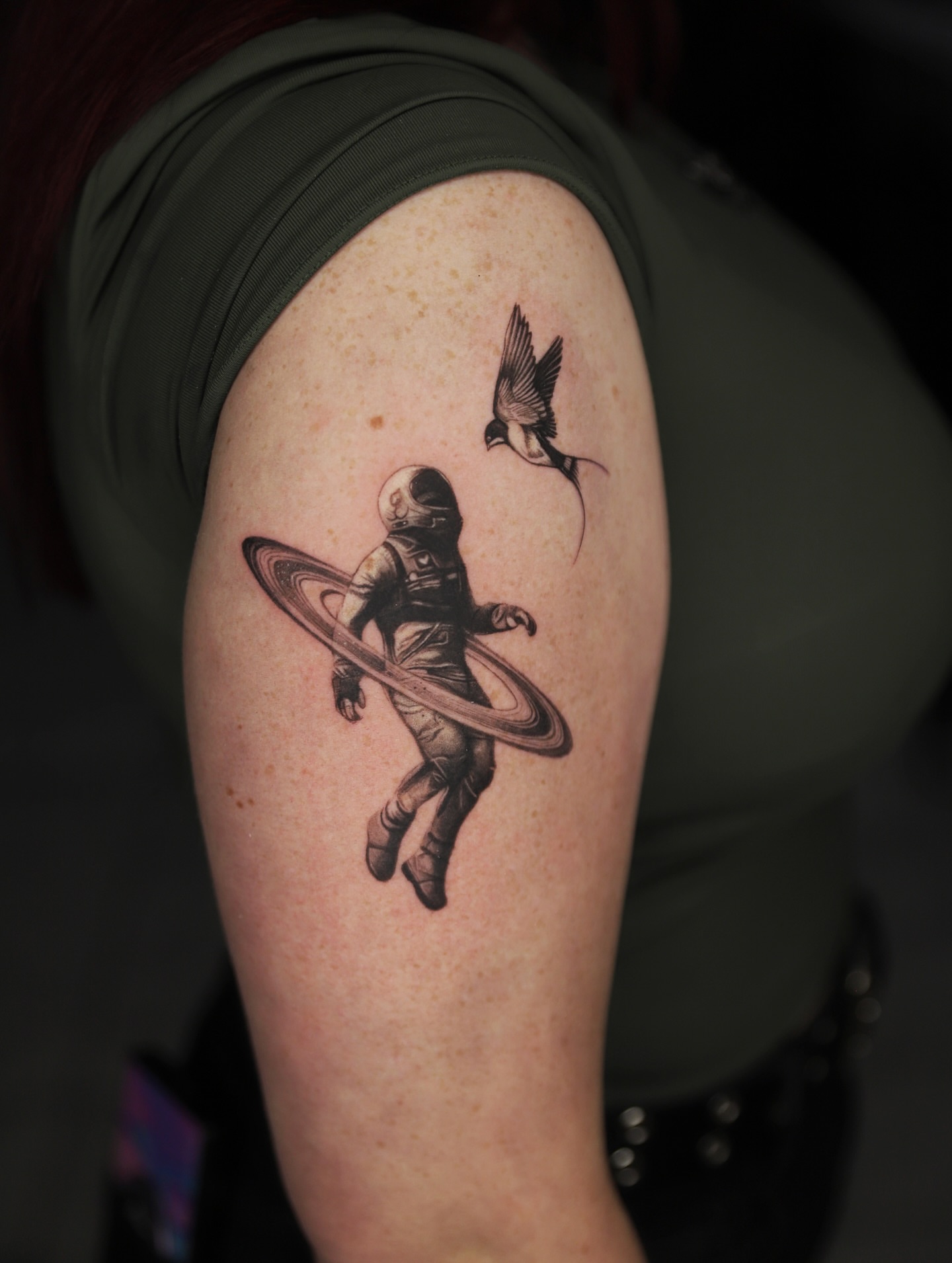 Astronaut with ring realism tattoo on the upper arm by Las Vegas tattoo