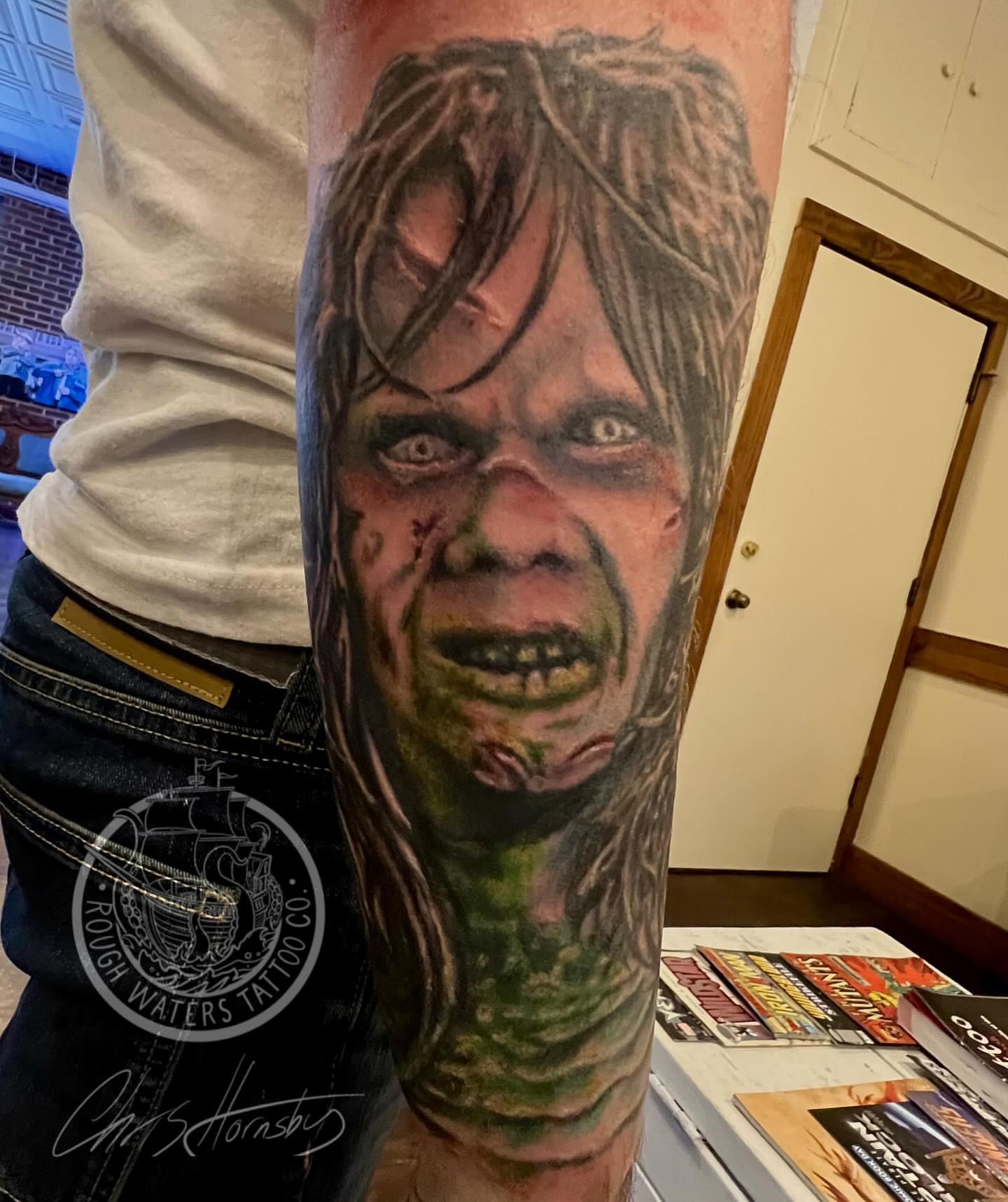 Zombie face realism tattoo on the forearm by Chris Hornsby