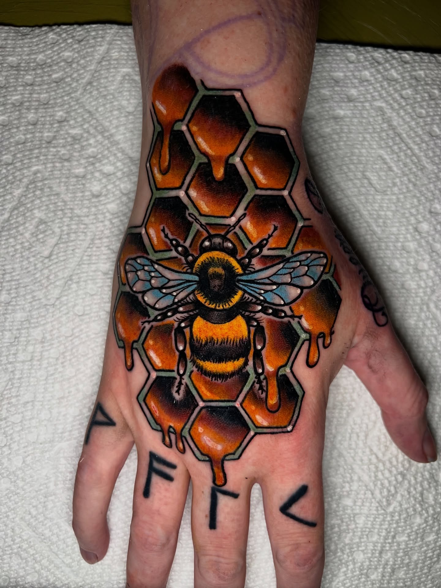 Bee and honeycomb geometric tattoo on the hand by Savannah Brayton, Bethlehem, Pennsylvania