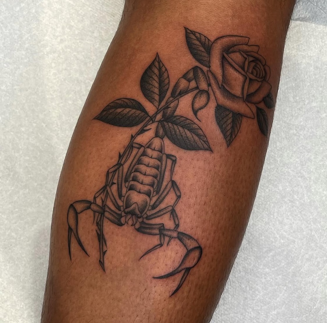 Scorpion and rose black and grey tattoo on the forearm by Dakota Jenner