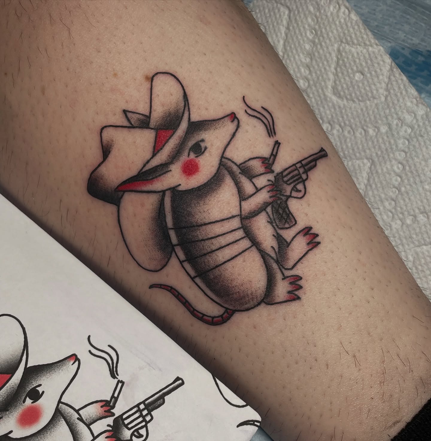 Armadillo with gun American traditional tattoo on the forearm by Marie π Tattoos
