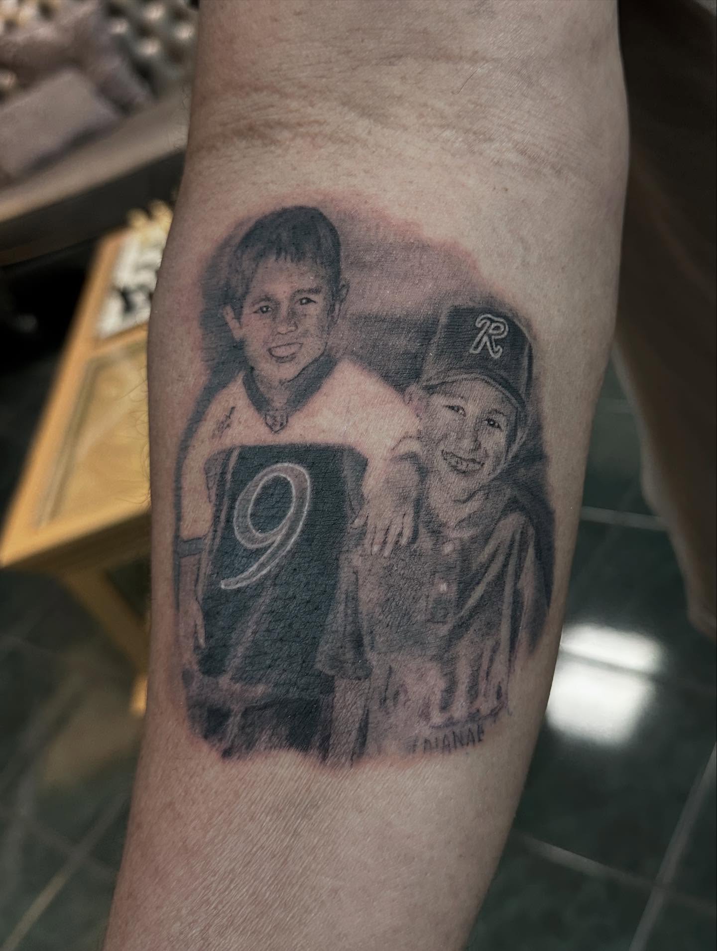 Portrait of two boys realism tattoo on the forearm by Healoha “Lindelle” Kamanu
