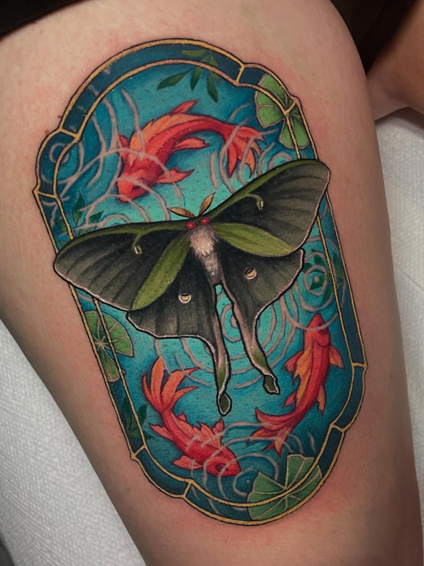 Luna moth and koi fish new school tattoo on the thigh by Leah Marie, Cincinnati
