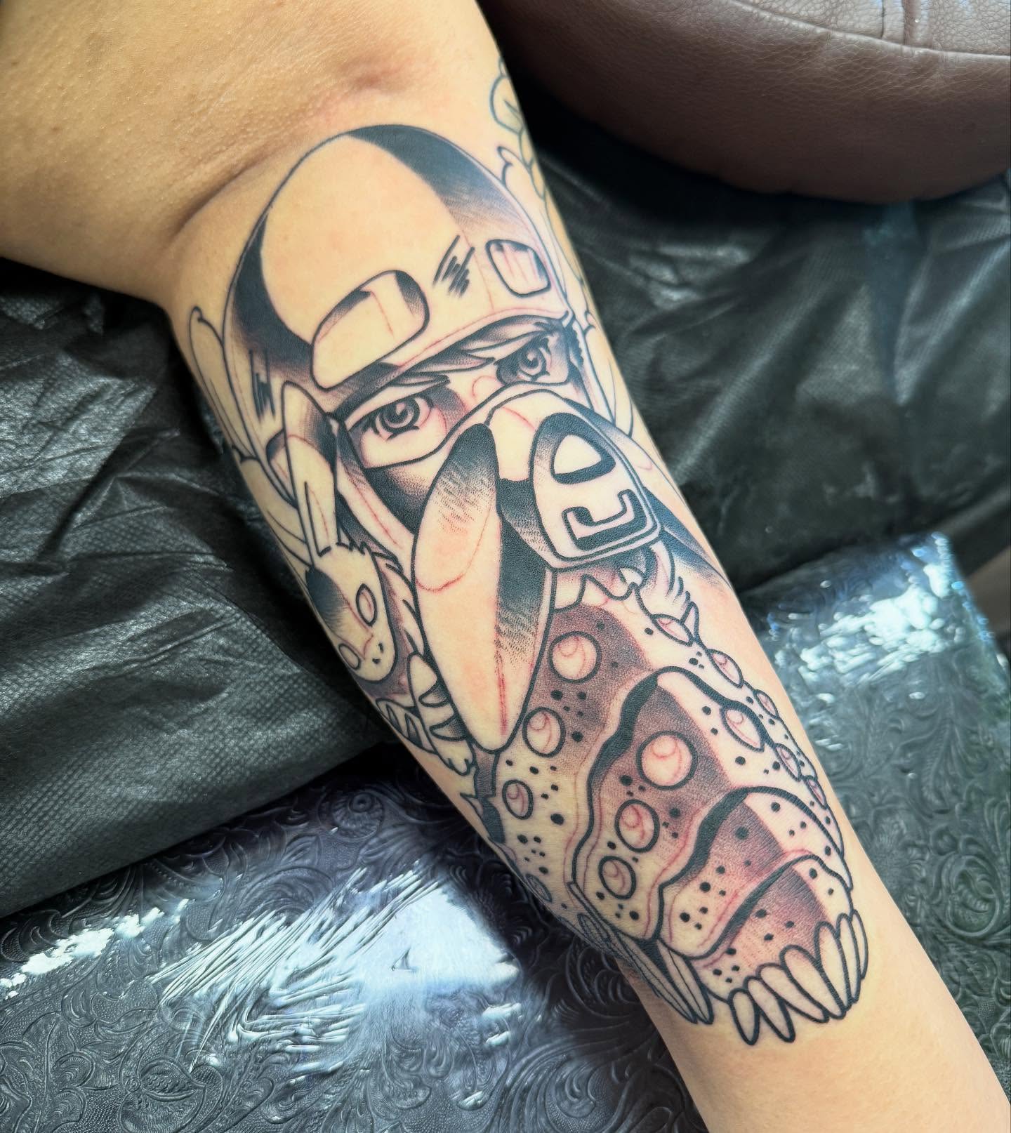 Robotic helmet dotwork tattoo on the forearm by Spencer Webb