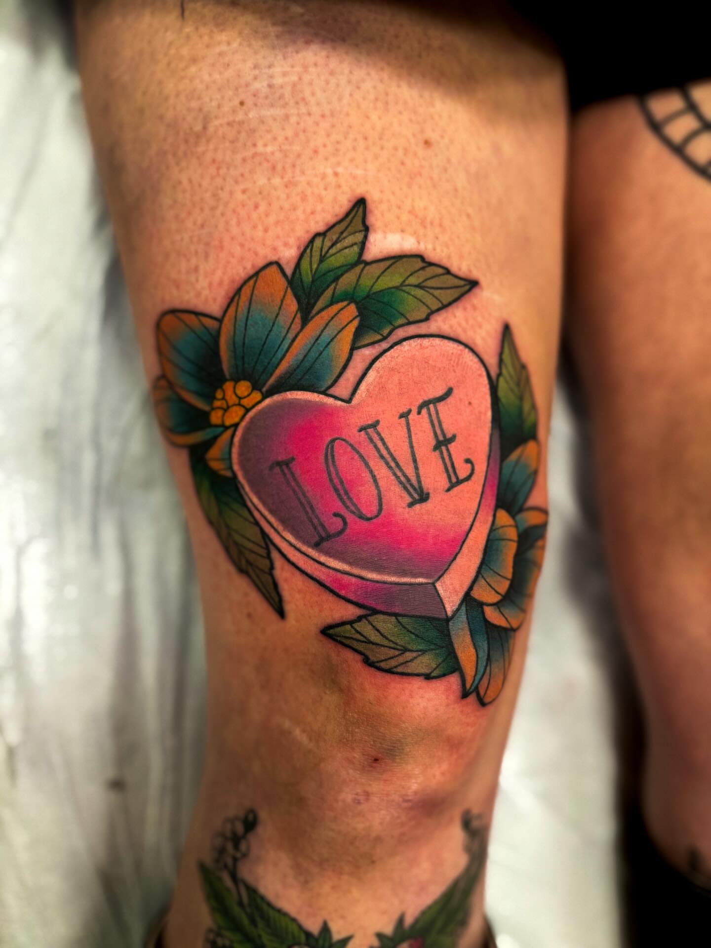 Heart with 'LOVE' American traditional tattoo on the forearm by Sam Babcock