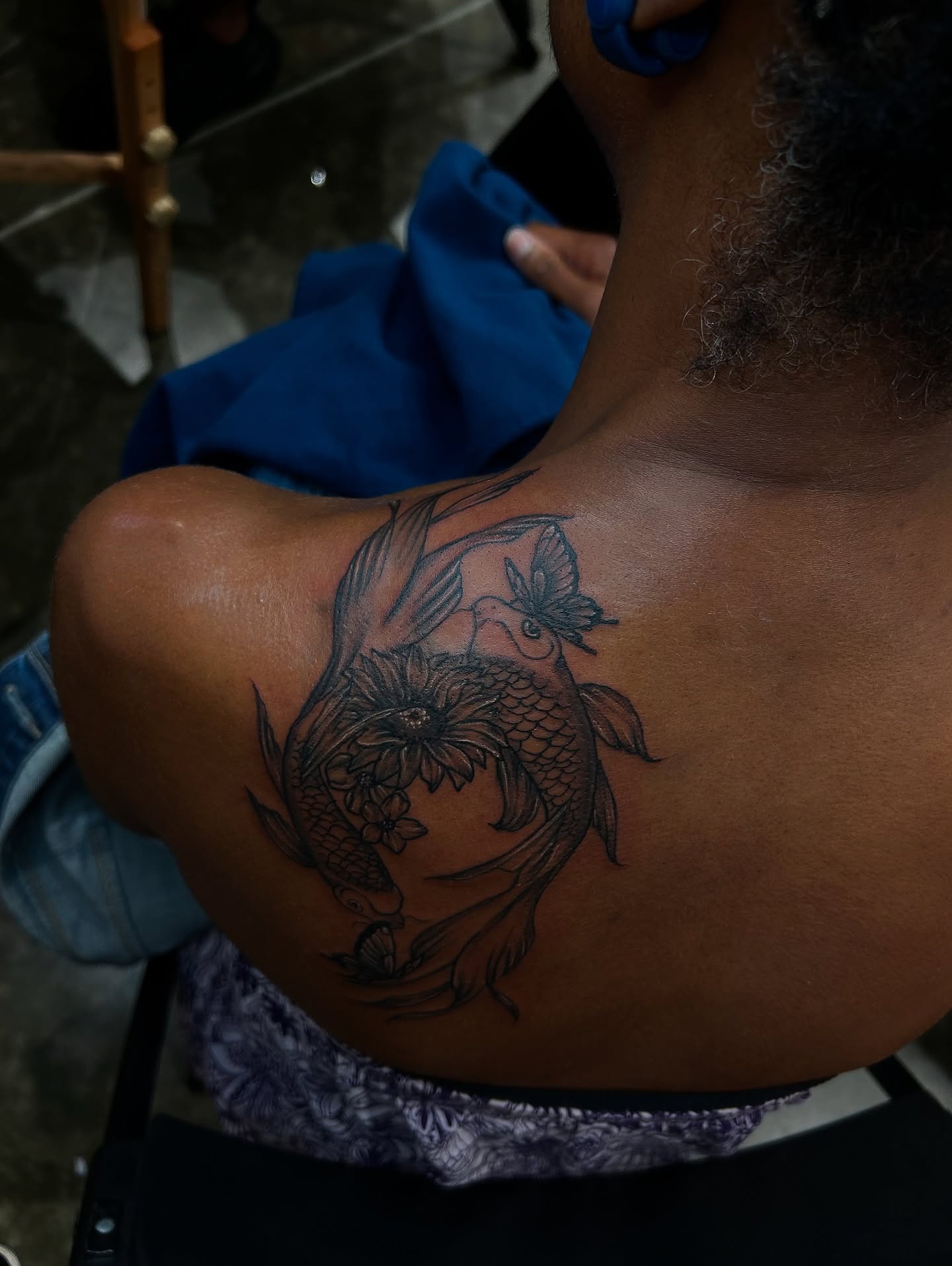 Koi fish and lotus flower black and grey tattoo on the shoulder by Porshamonie' THE Tattoo ARTIST