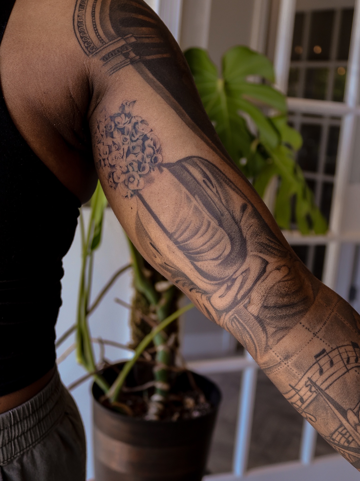 Buddha statue black and grey tattoo on the forearm by Beans