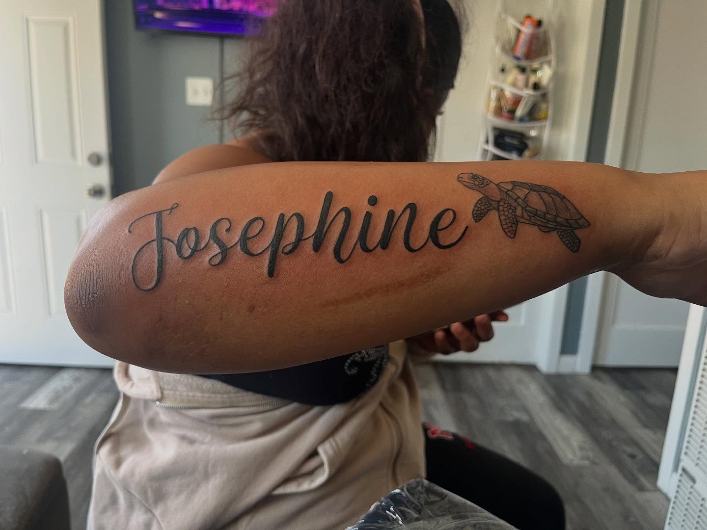 Name with turtle black and grey tattoo on the forearm by Bris