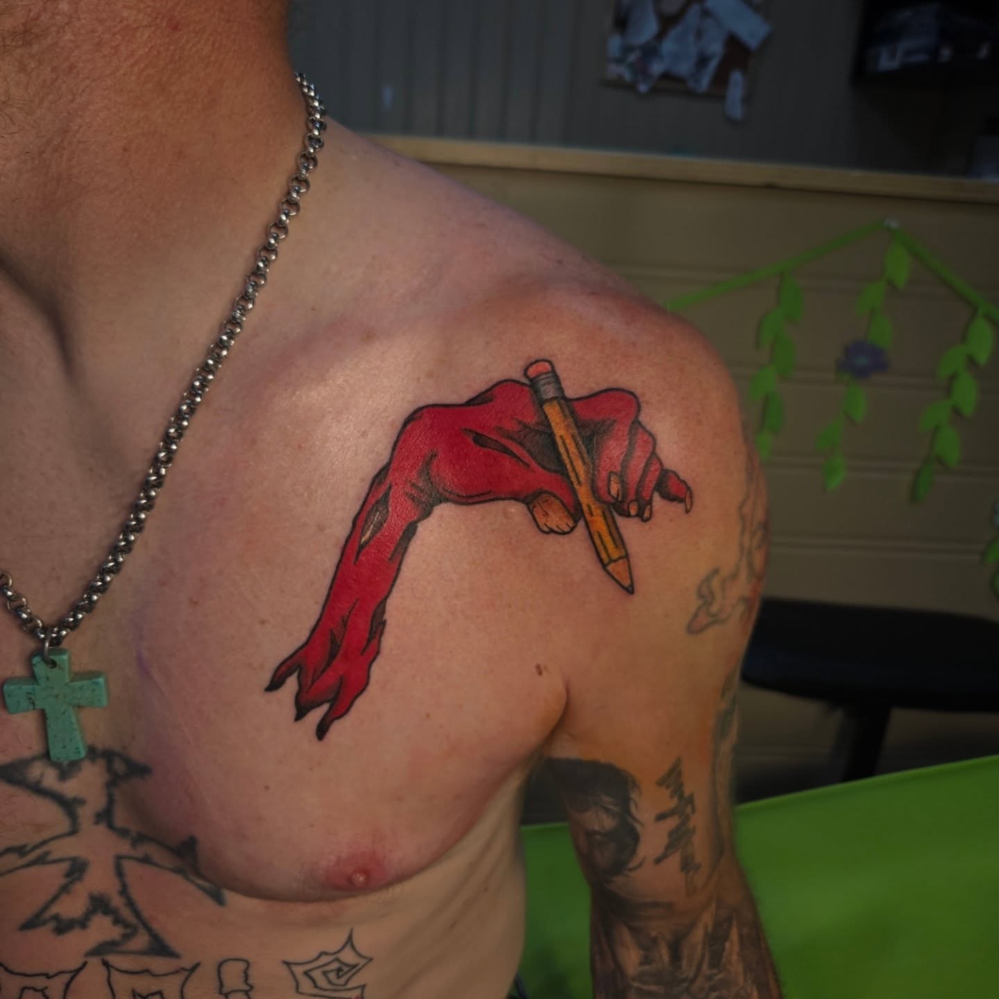 Red hand holding pencil realism tattoo on the shoulder by Abigail (Bgail) Boyd