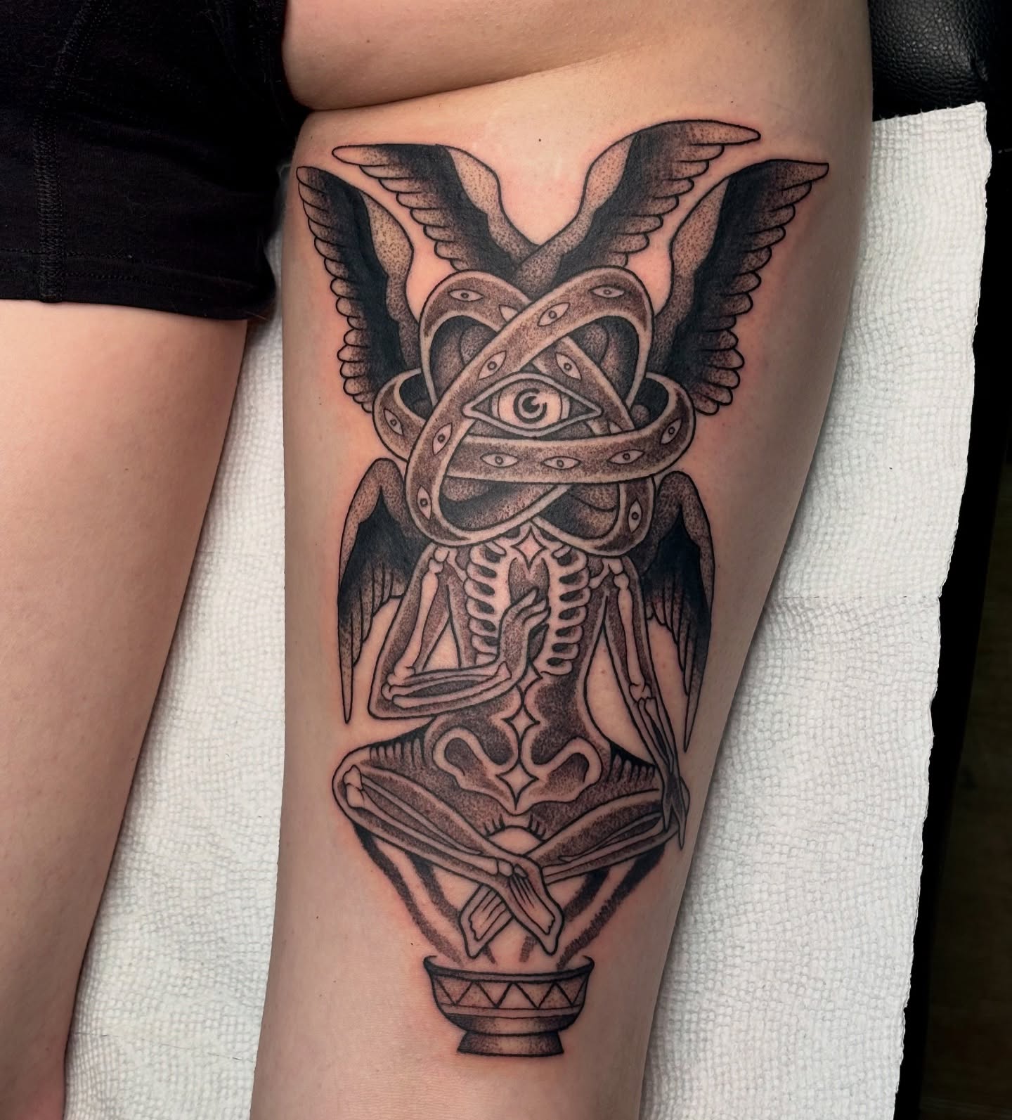 Skeleton with snake dotwork tattoo on the thigh by Jordan Wray