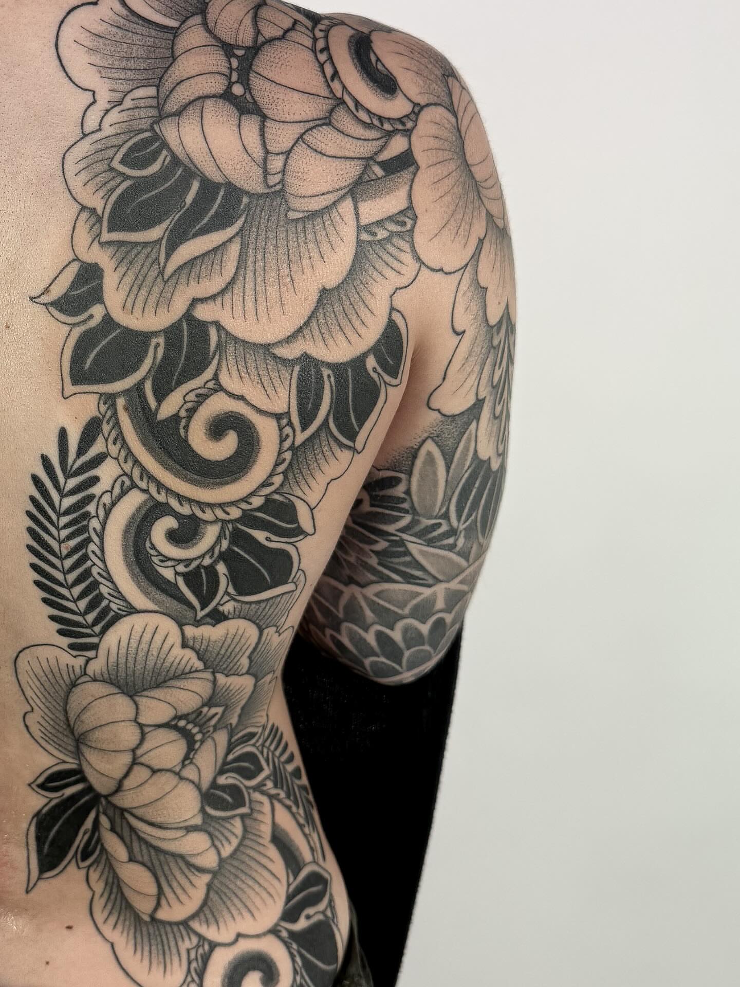 Floral bouquet black and grey tattoo on the upper arm by Jamie Beach, Wheat Ridge, Colorado