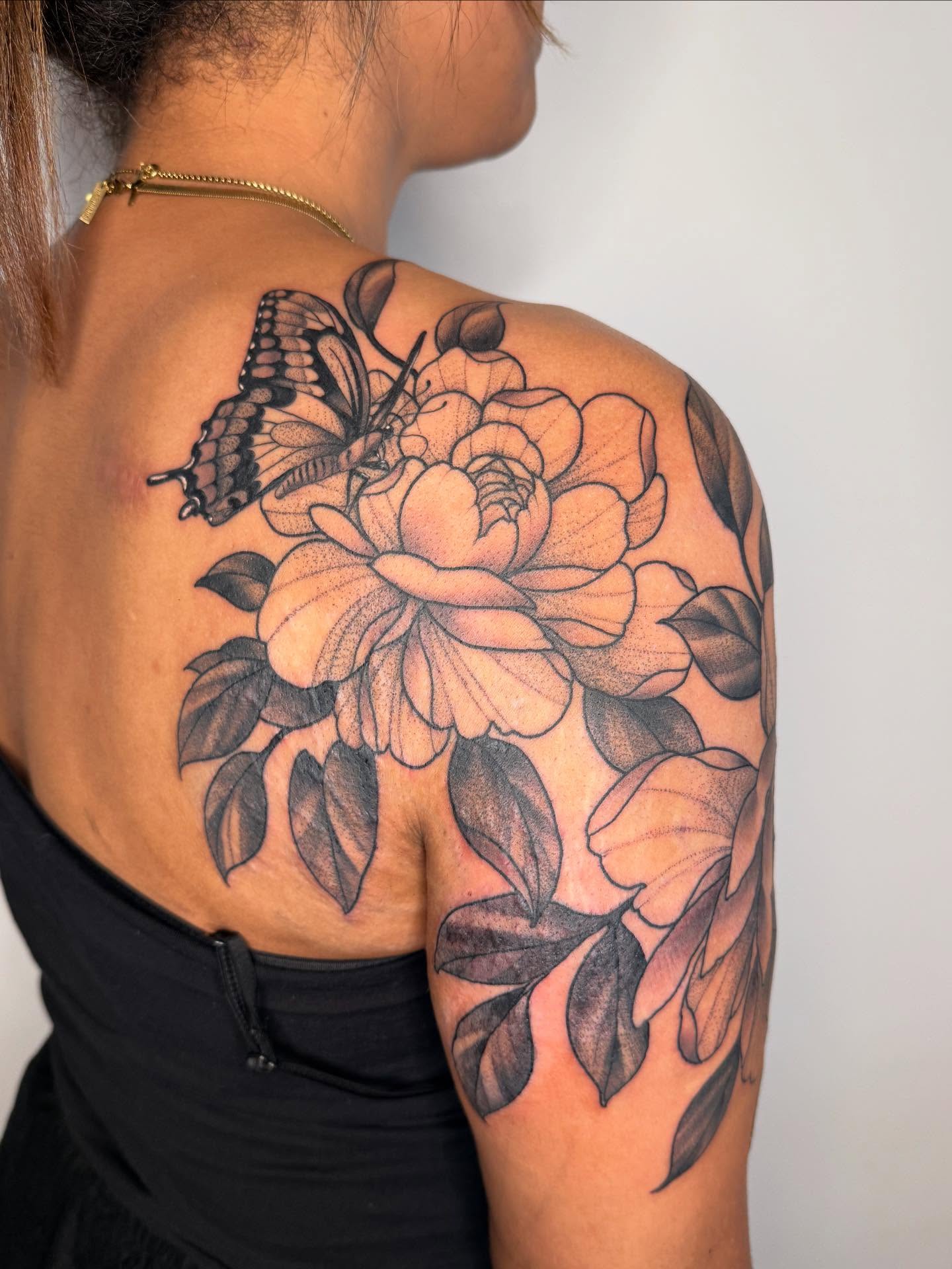Peony and butterfly dotwork tattoo on the shoulder by Samantha Compasso Ford