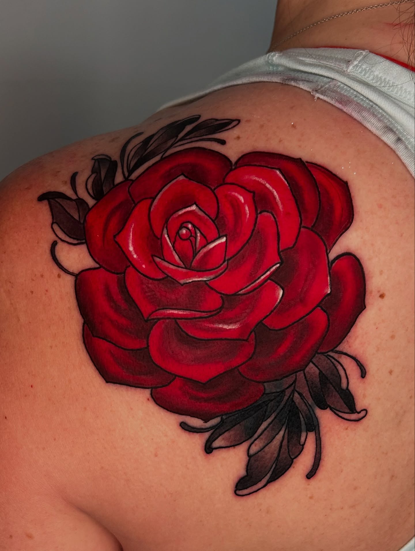 Red rose realism tattoo on the shoulder by Laura Babsie