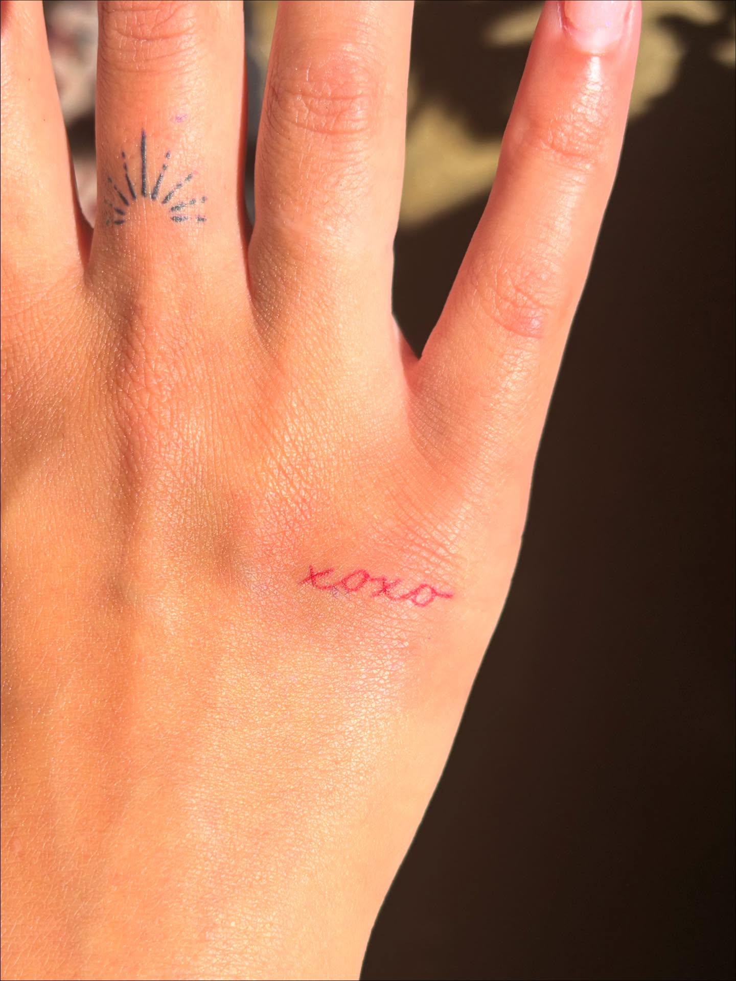 Xoxo lettering script tattoo on the hand by Anna Kathleen, Des Moines, Iowa
