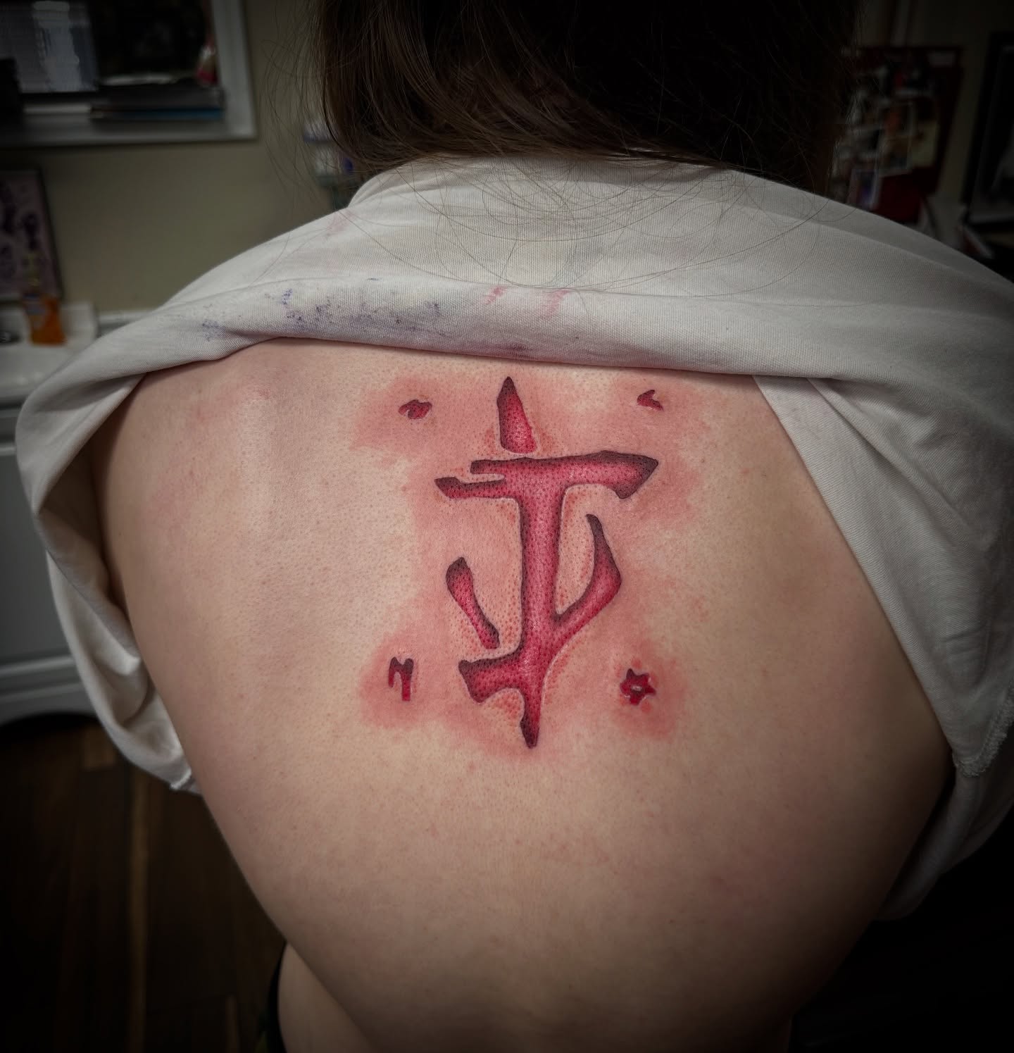 Symbol geometric tattoo on the back by Bosco Layne