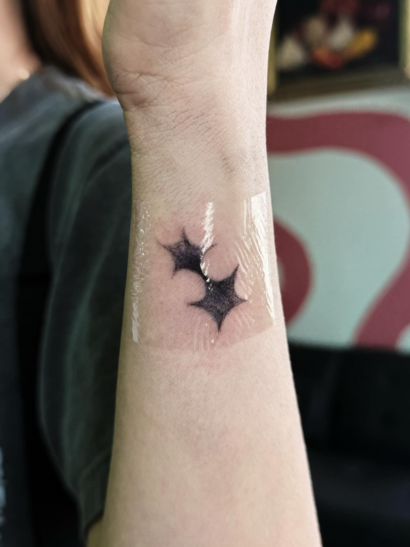Star black and grey tattoo on the forearm by Paulina Vazquez
