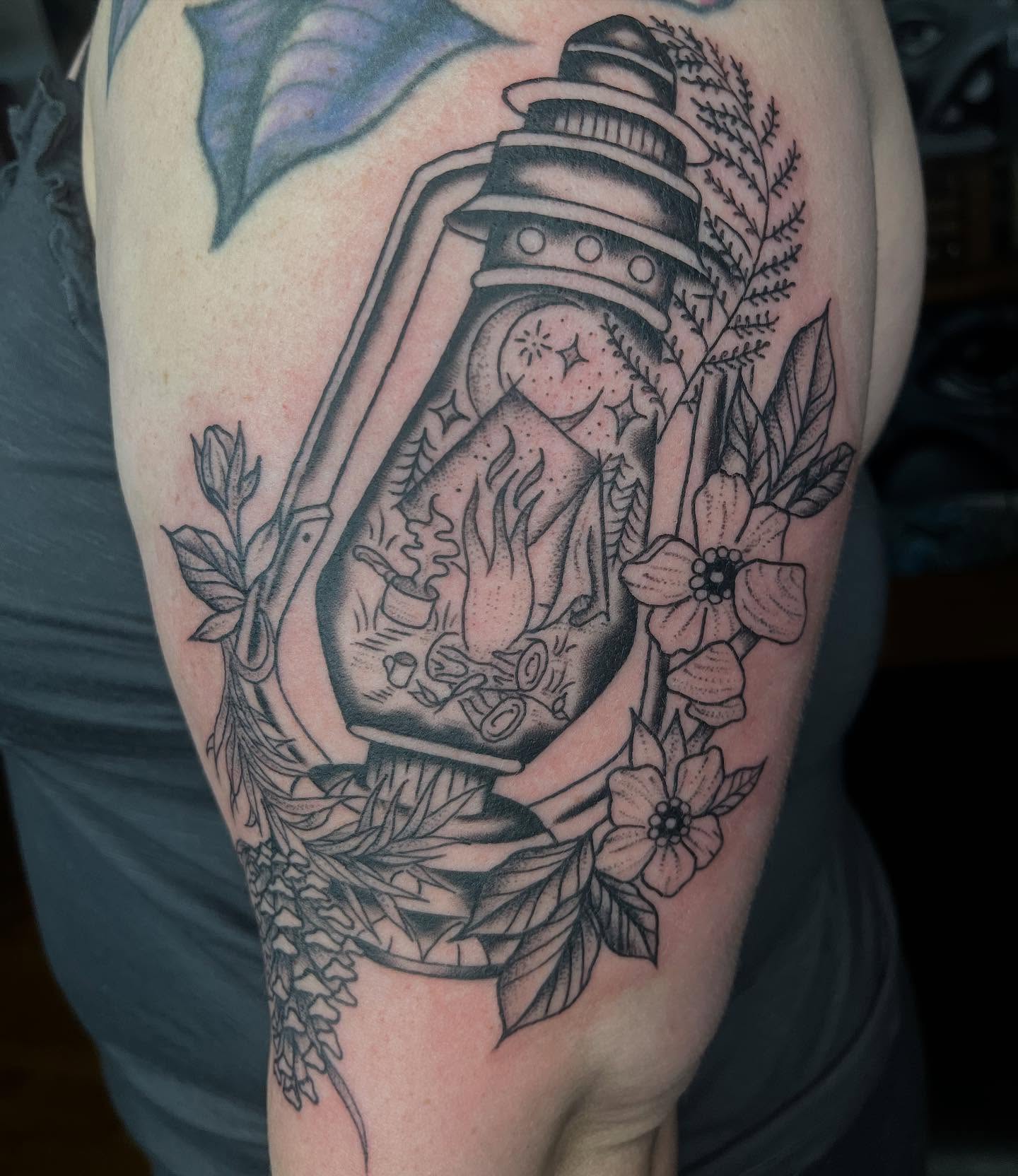Lantern and flowers black and grey tattoo on the forearm by Mariah Nguyen