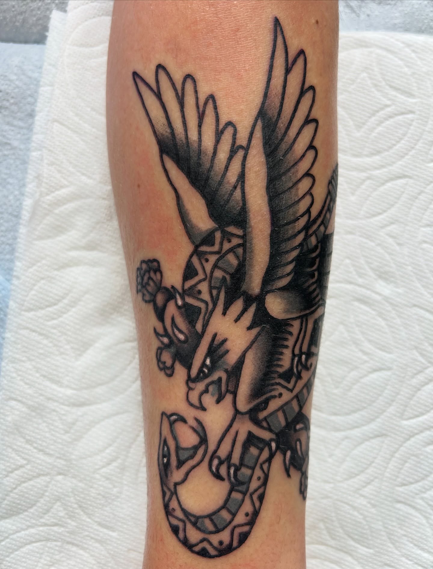 Bird and snake American traditional tattoo on the forearm by Joey Delarosa, San Francisco, California