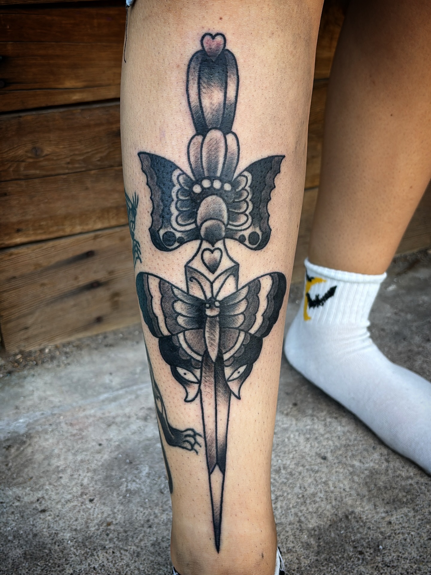 Butterfly and dagger American traditional tattoo on the calf by Tattoos Las Vegas,NV