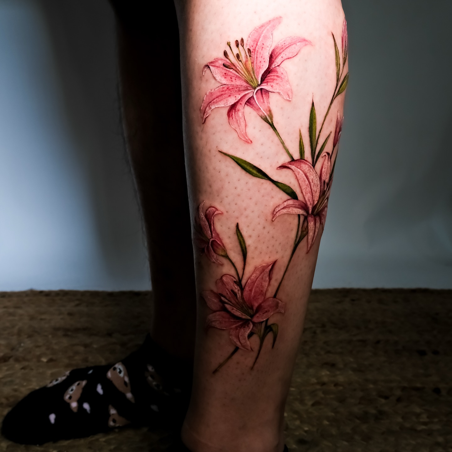 Lilies realism tattoo on the calf by NAS
