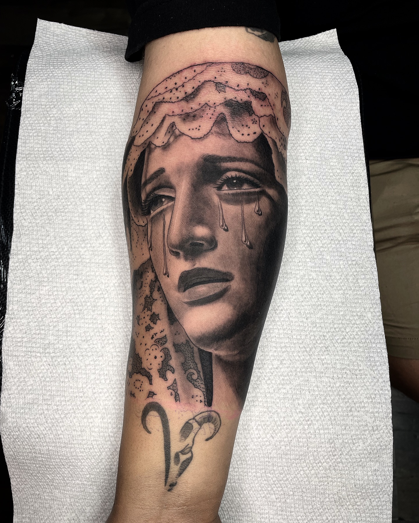 Woman's face realism tattoo on the forearm by Alex Ortiz