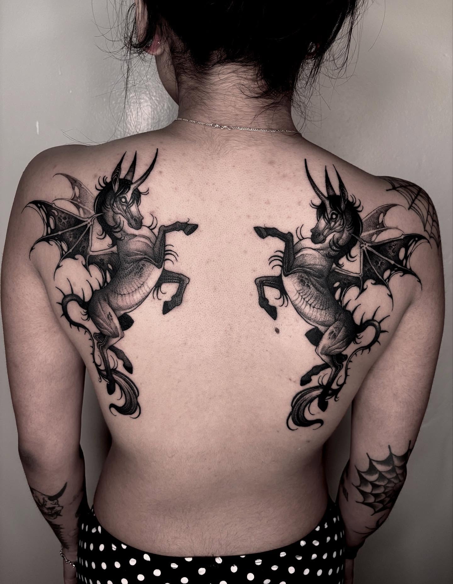 Unicorns with wings black and grey tattoo on the back by Jens