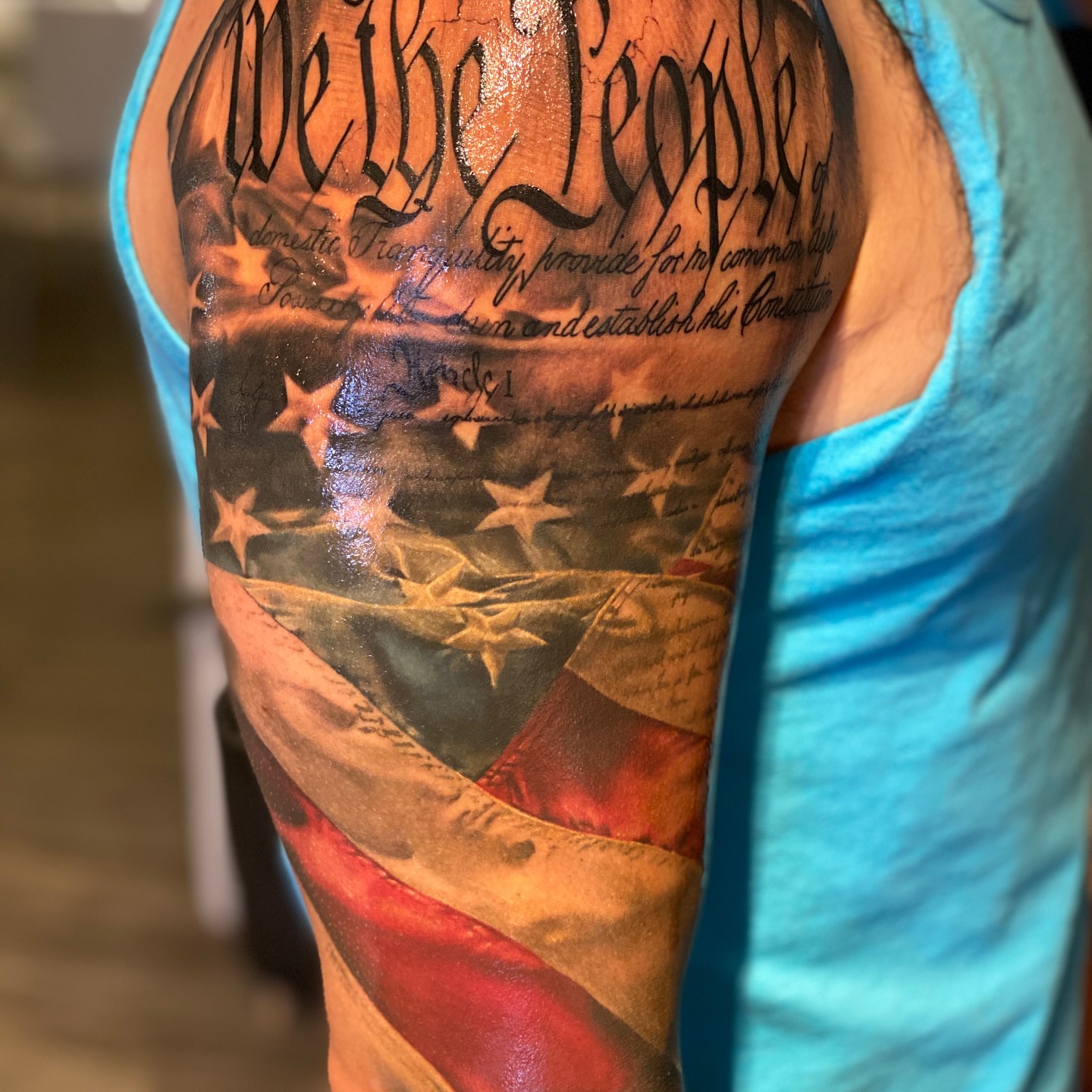 American flag and Constitution American traditional tattoo on the upper arm by Justin Shelpman