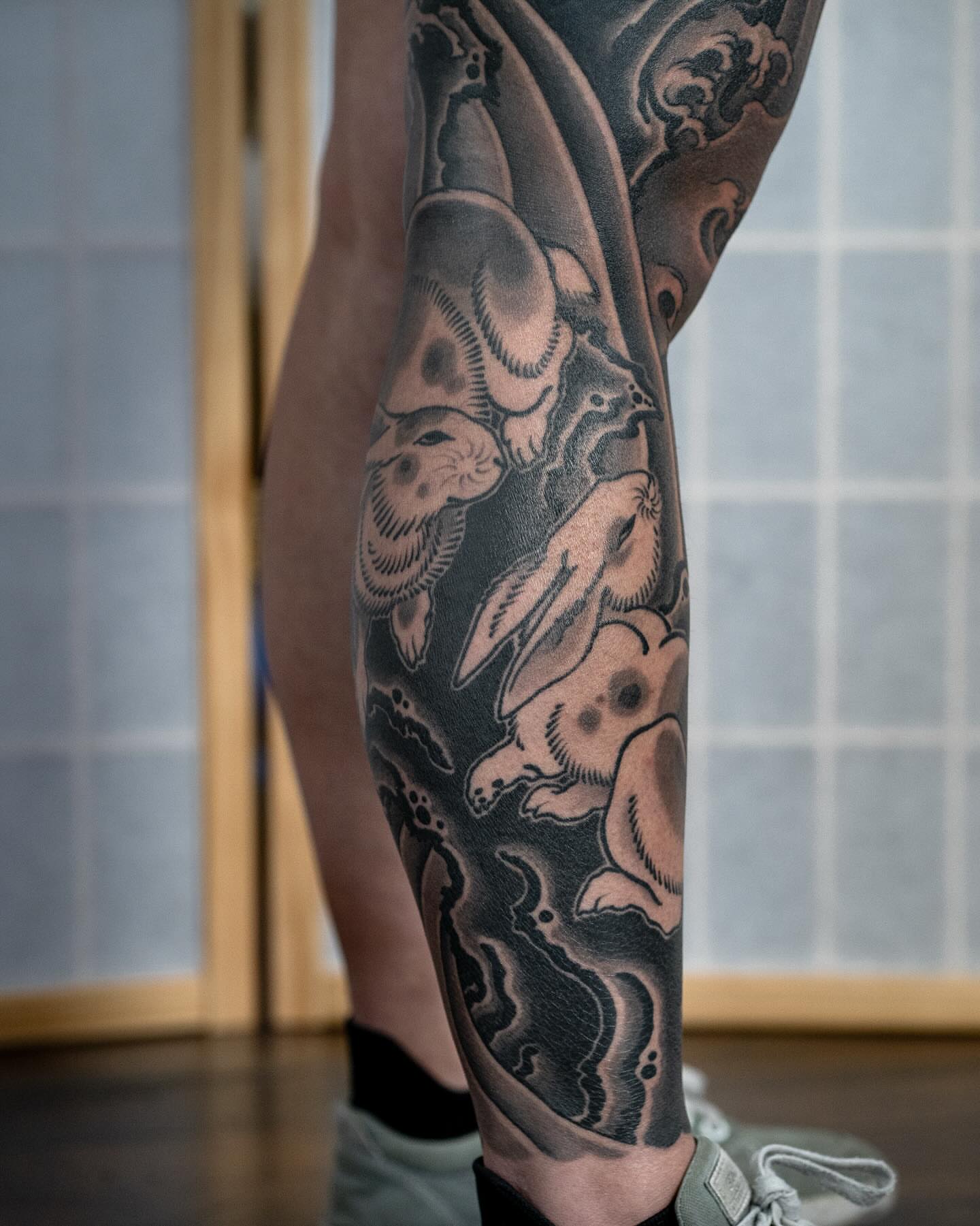 Rabbits black and grey tattoo on the calf by Matt Leibo, San Francisco, California