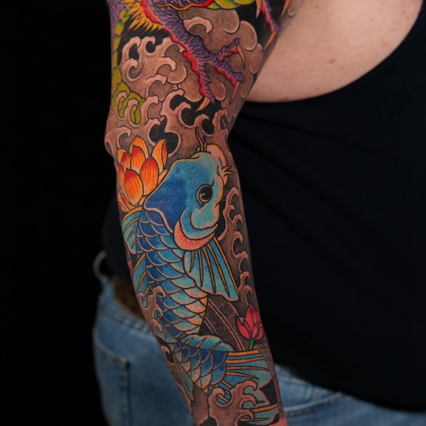 Koi fish and lotus japanese irezumi tattoo on the forearm by Mitch Bonifay