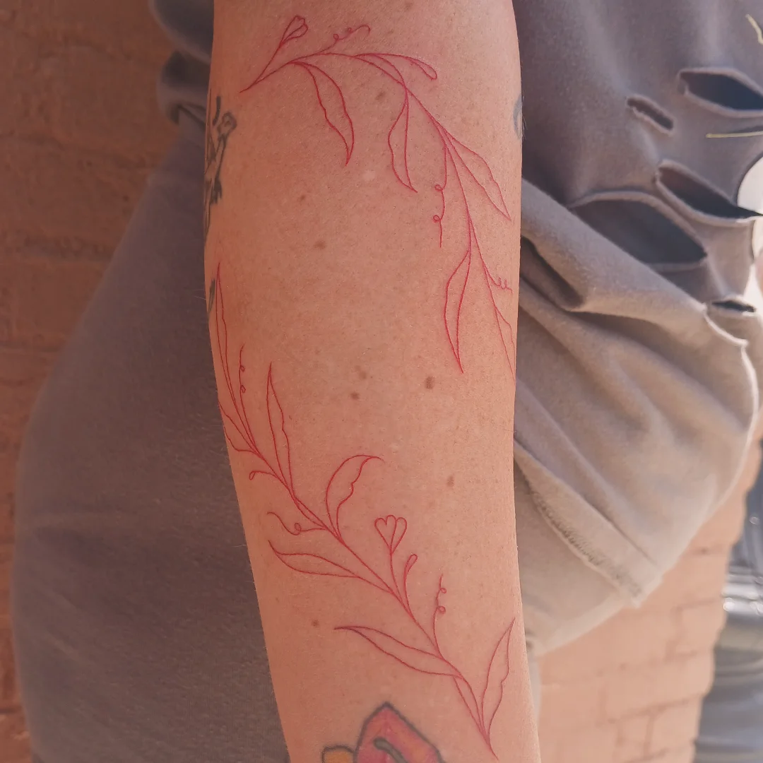 Floral vine fine line tattoo on the forearm by Cassieal Welch
