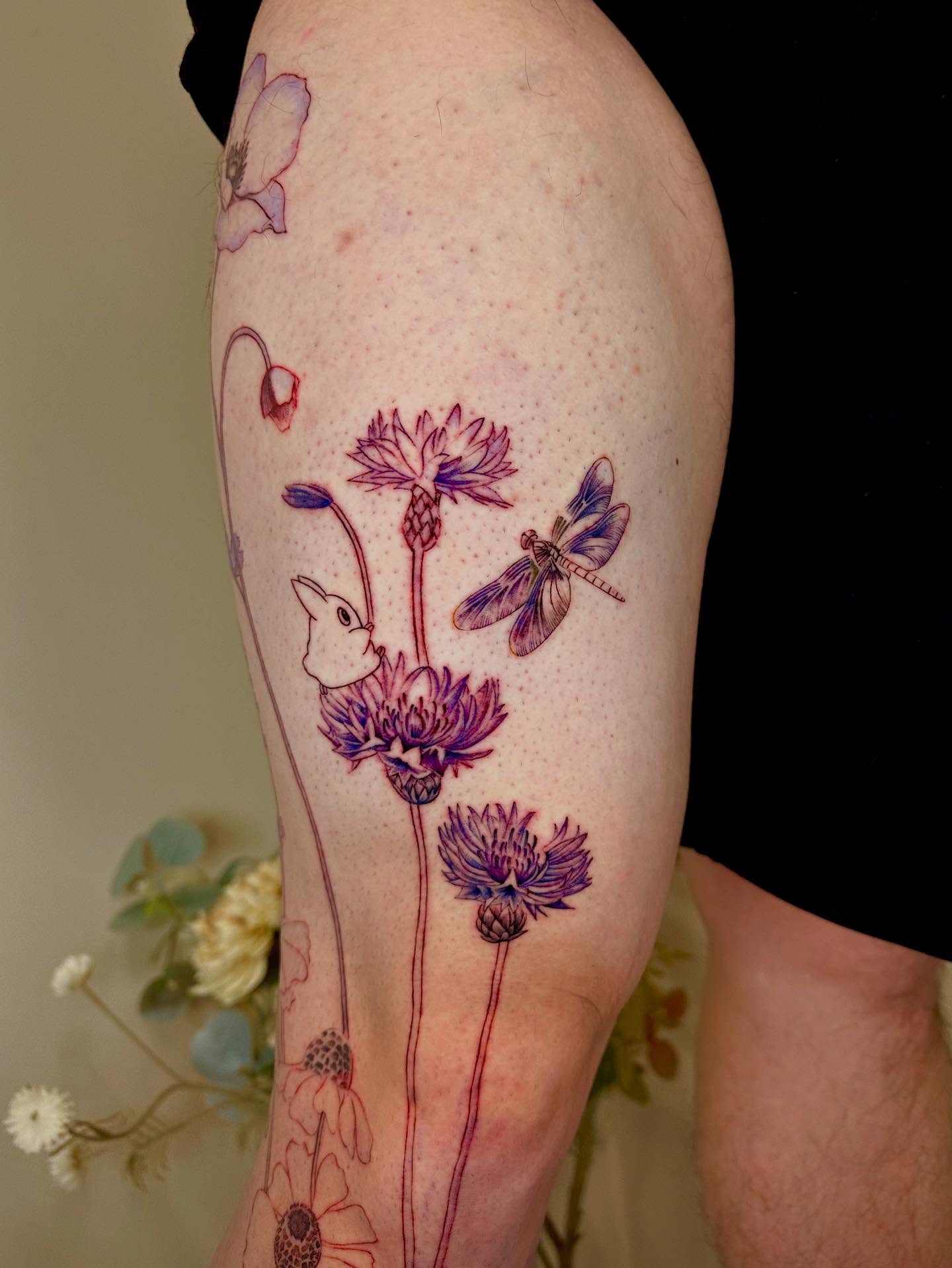 Flowers and dragonfly dotwork tattoo on the forearm by Claire