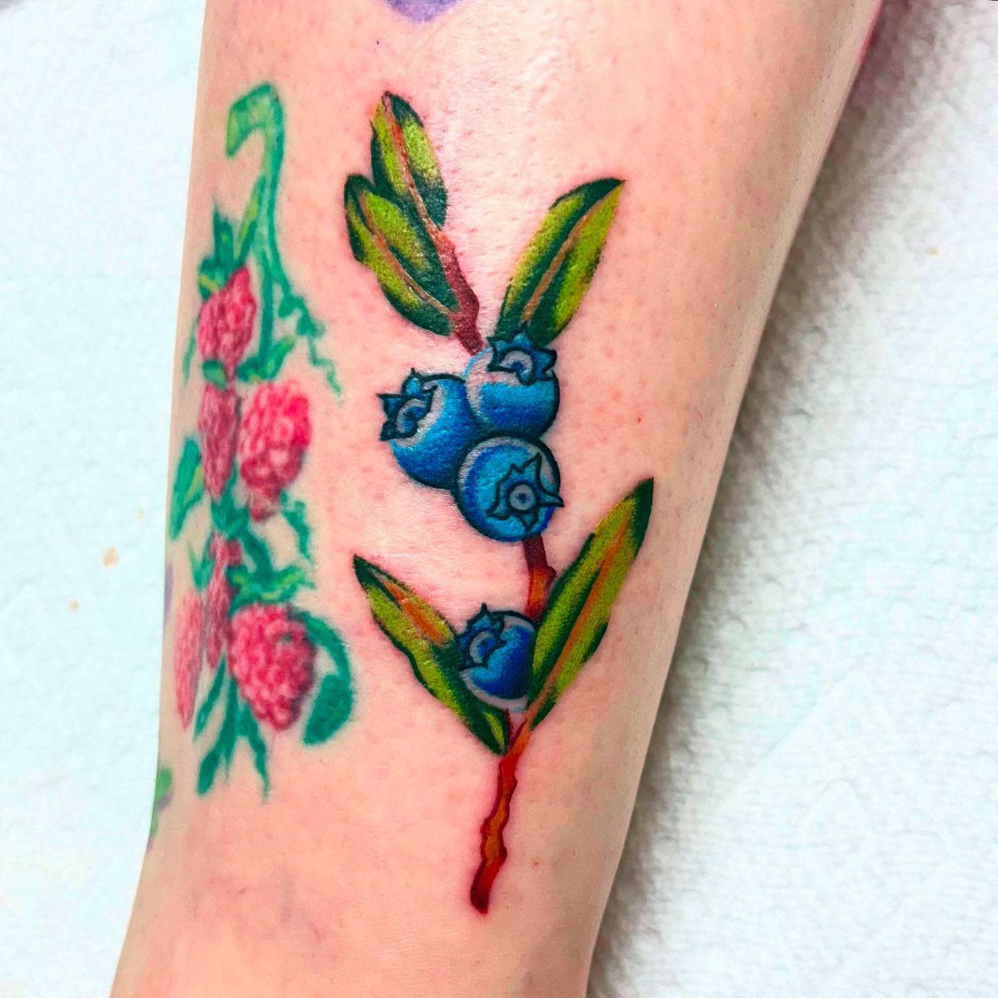 Blueberries American traditional tattoo on the forearm by Rebecca Lang