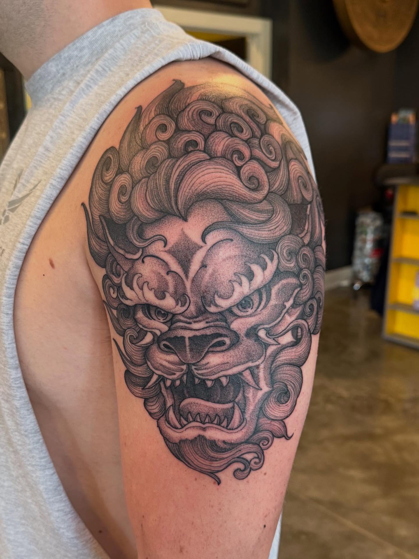 Lion head black and grey tattoo on the shoulder by Will Campbell