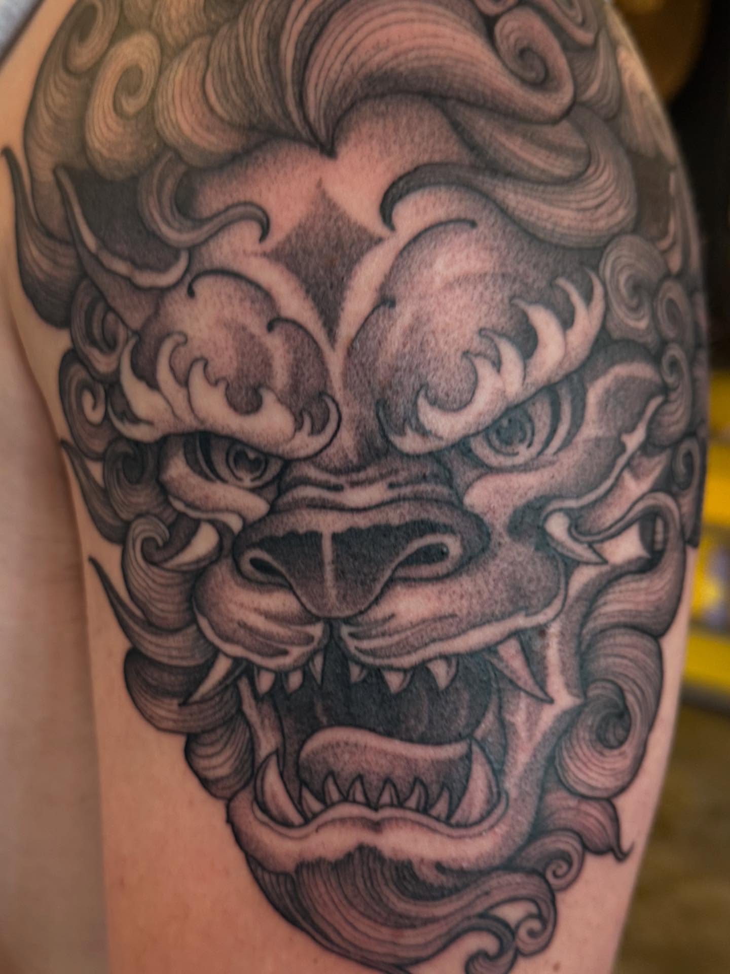 Lion black and grey tattoo on the shoulder by Will Campbell