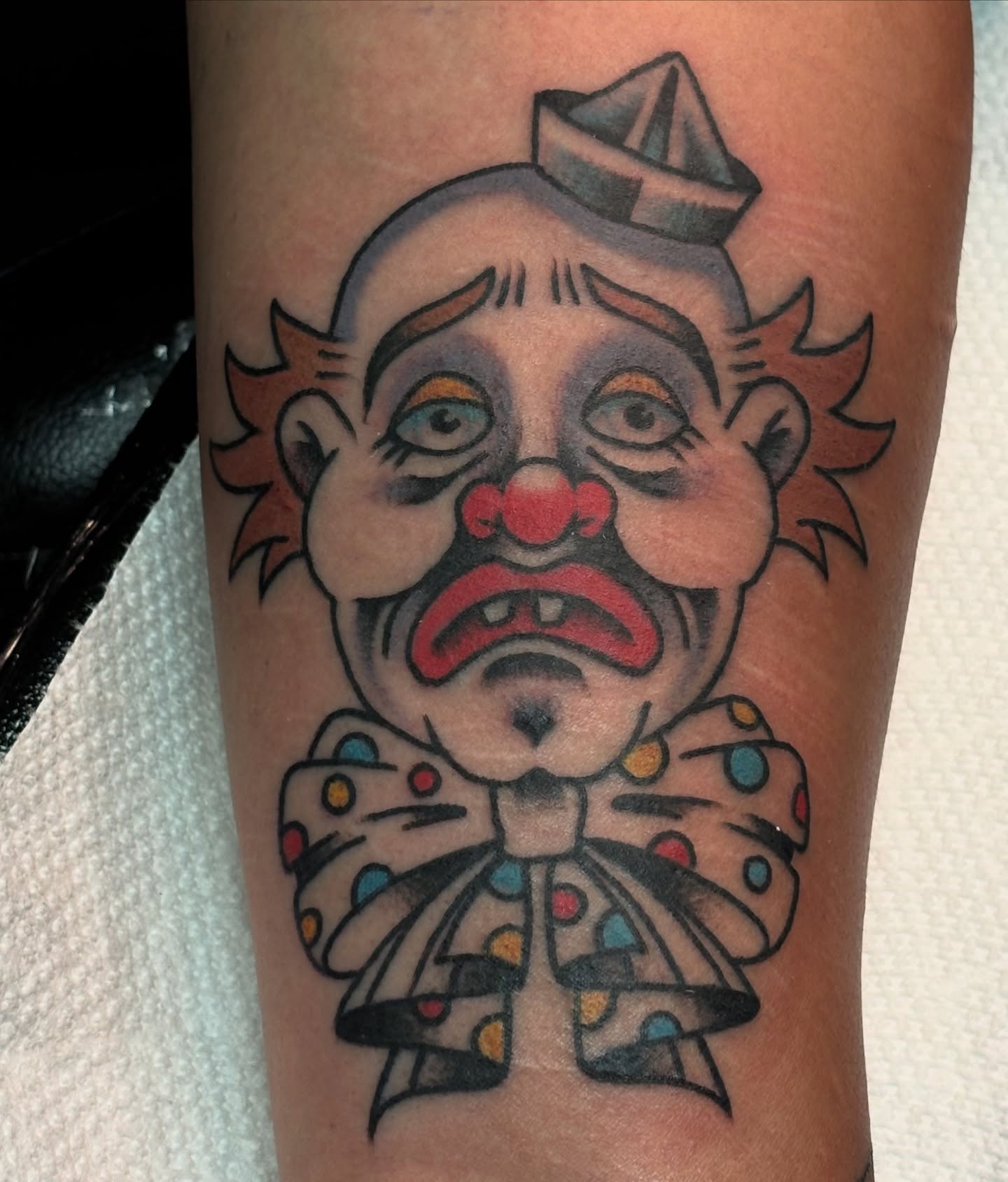 Clown American traditional tattoo on the forearm by Jordan Wray