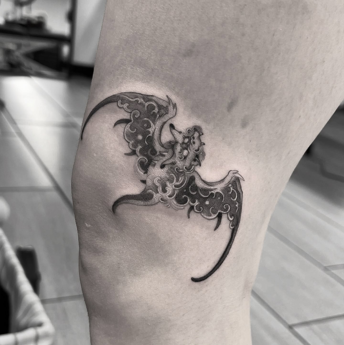 Mythical creature black and grey tattoo on the thigh by Joshua Hung, Alhambra, California