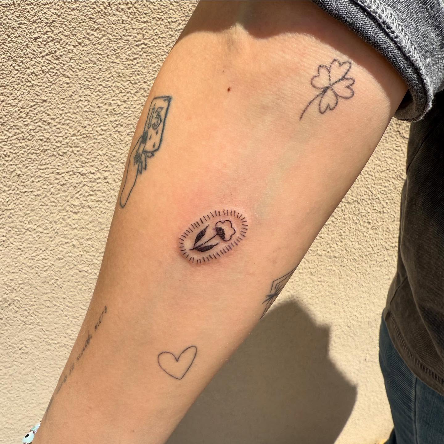 Sewing needle and thread black and grey tattoo on the forearm by Kylee Snow