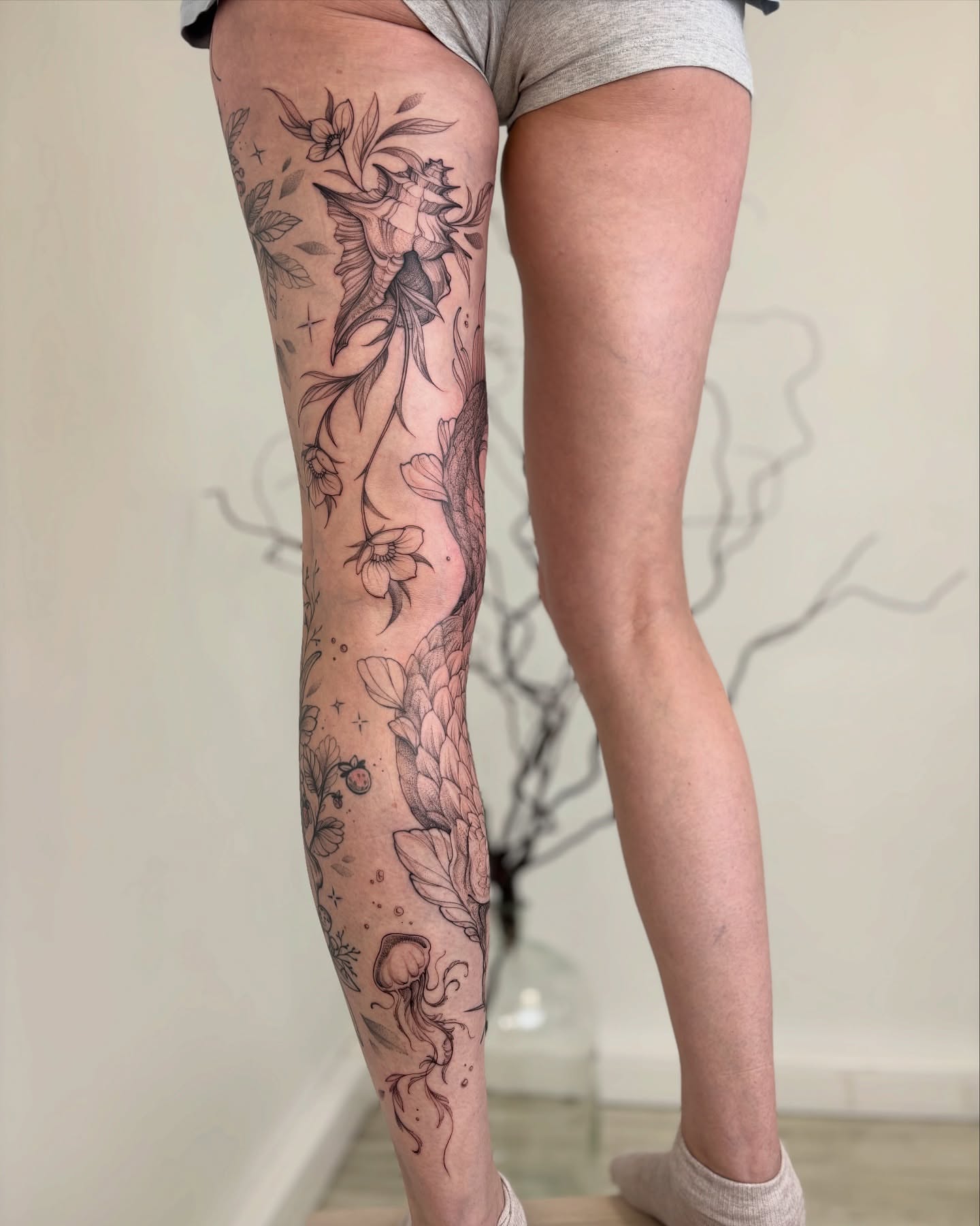 Floral and jellyfish fine line tattoo on the calf by vaprol tattoo ✧ Boston