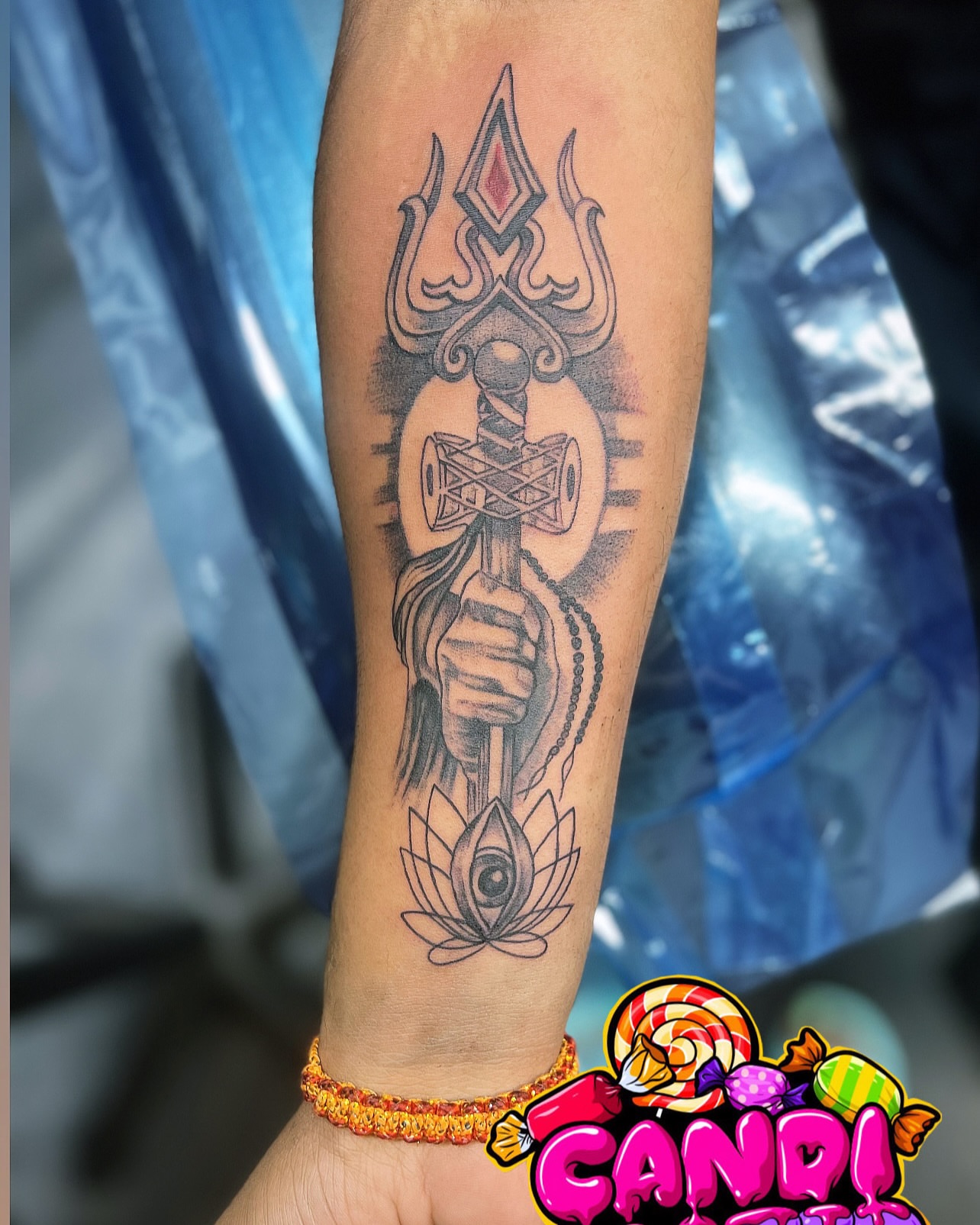 Trident and lotus black and grey tattoo on the forearm by CandiCoatedInk