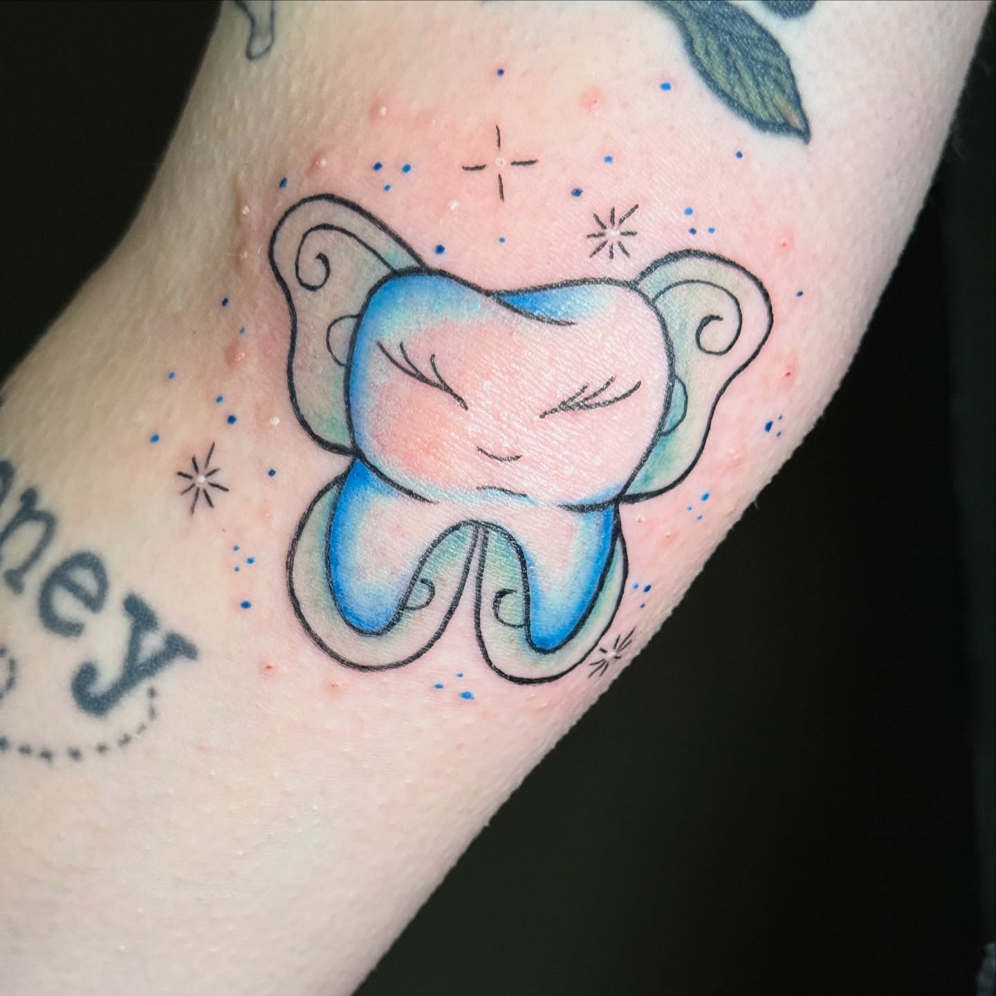 Tooth watercolor tattoo on the forearm by Whimsical illustrative