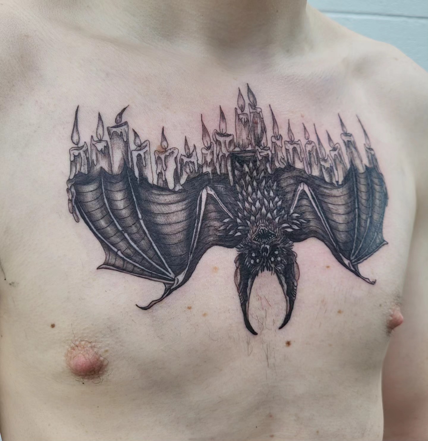 Bat with candles dark realism tattoo on the chest by Jenna 🖤 Tattoos Denton TX