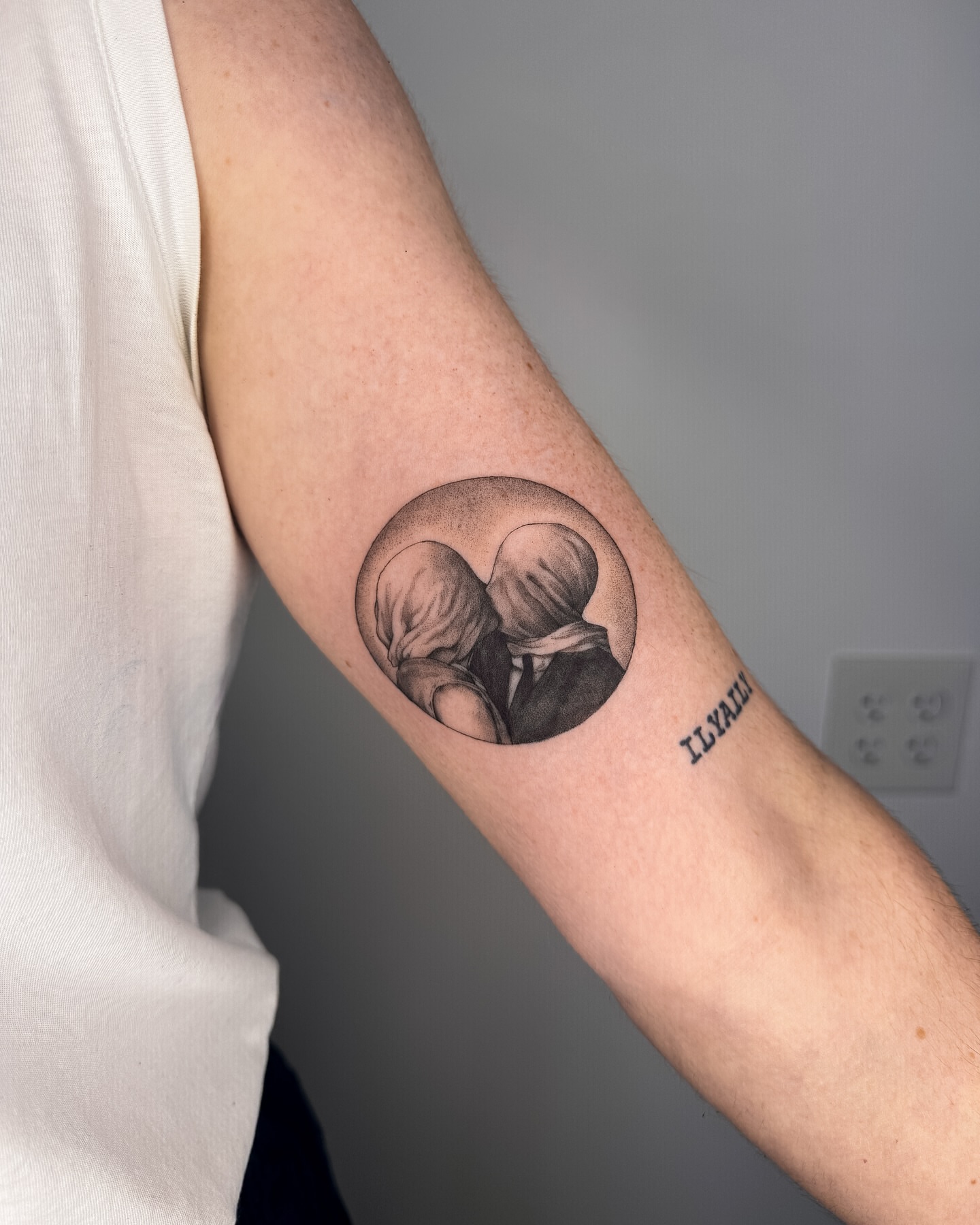 Couple embracing black and grey tattoo on the forearm by Emma- Los Angeles Tattoo Artist