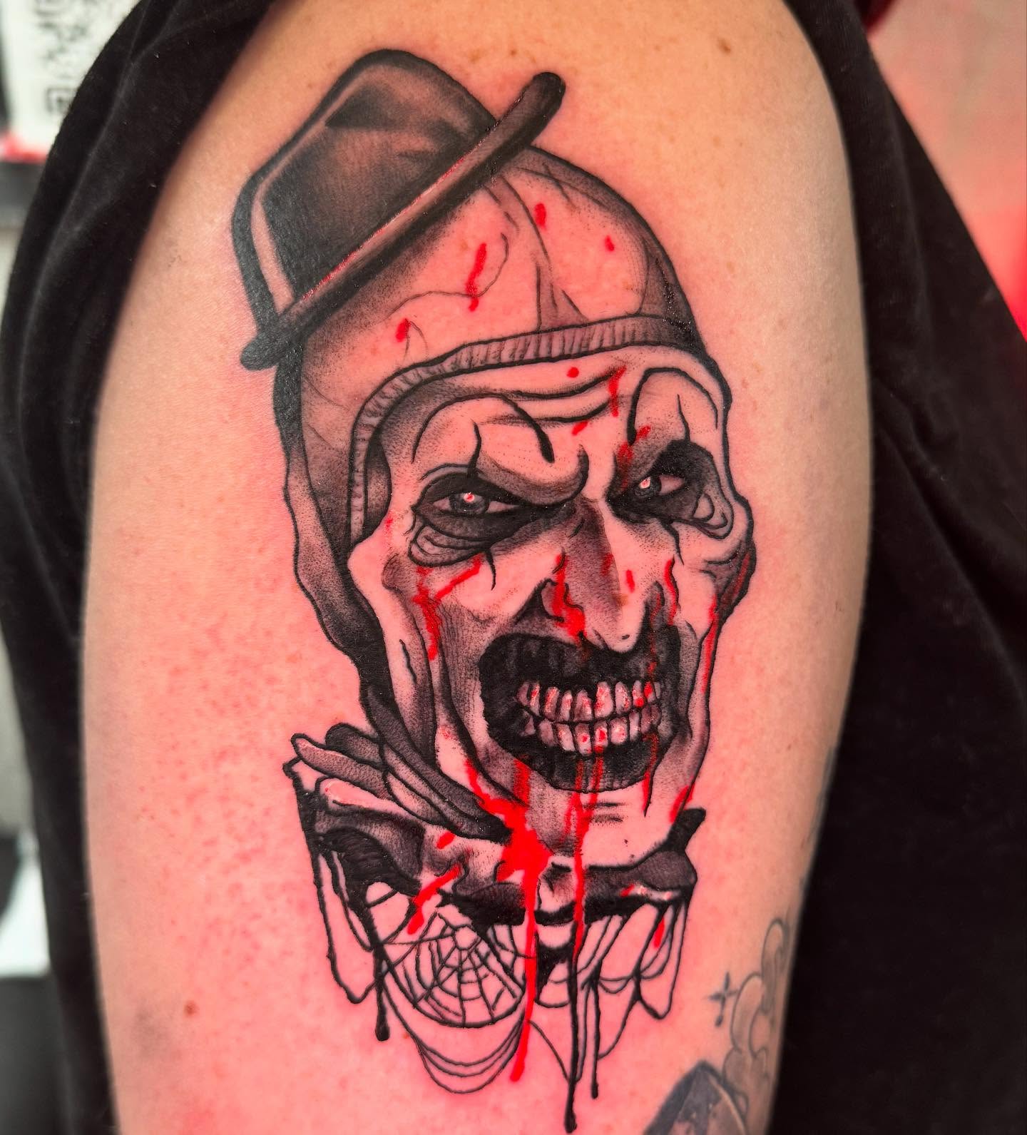 Clown dark realism tattoo on the shoulder by Therapy ink