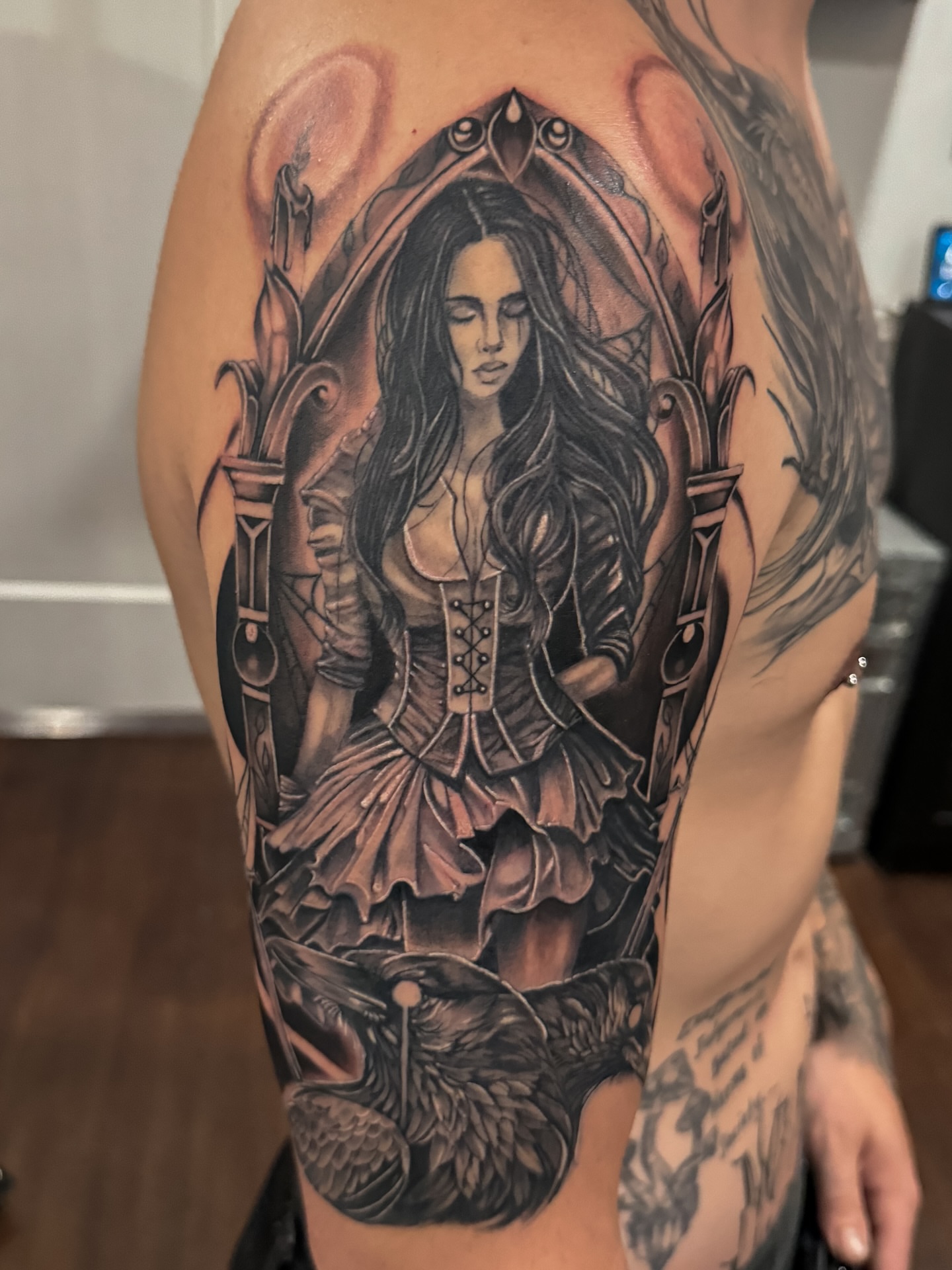 Woman in corset realism tattoo on the shoulder by Travis Sleeper