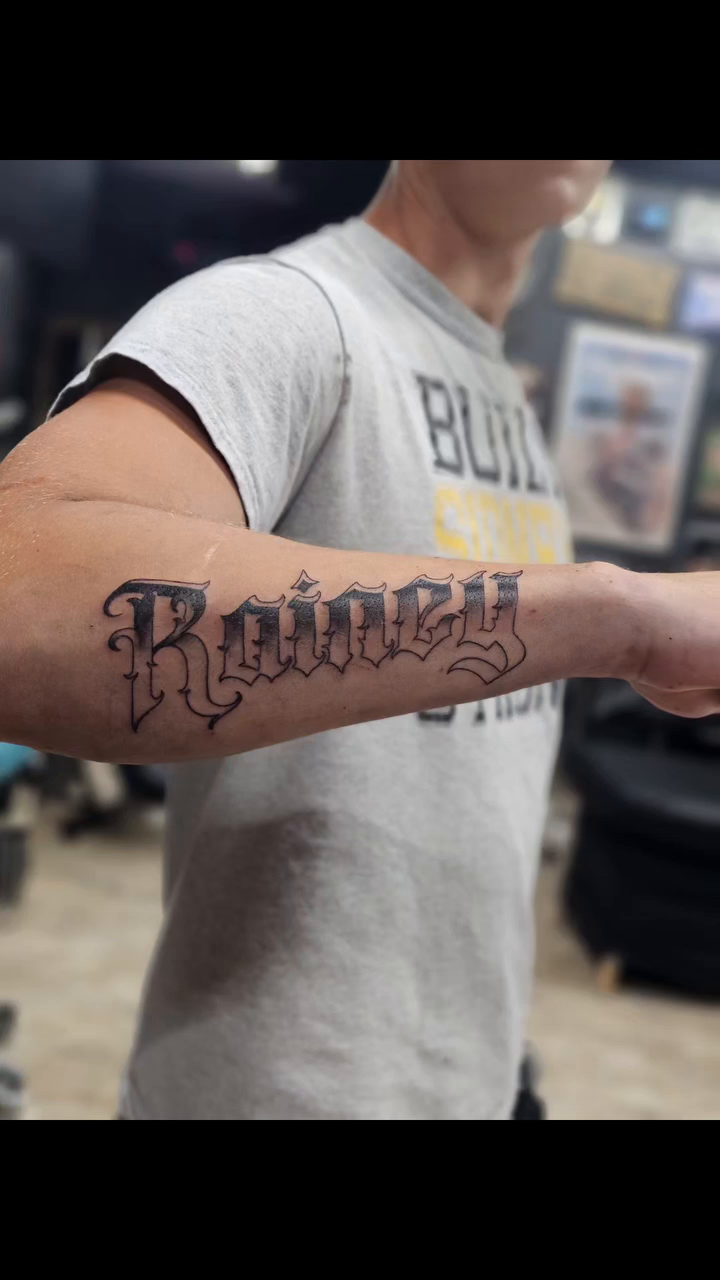 Rainey script tattoo on forearm tattoo on the upper arm by Nadine ☥
